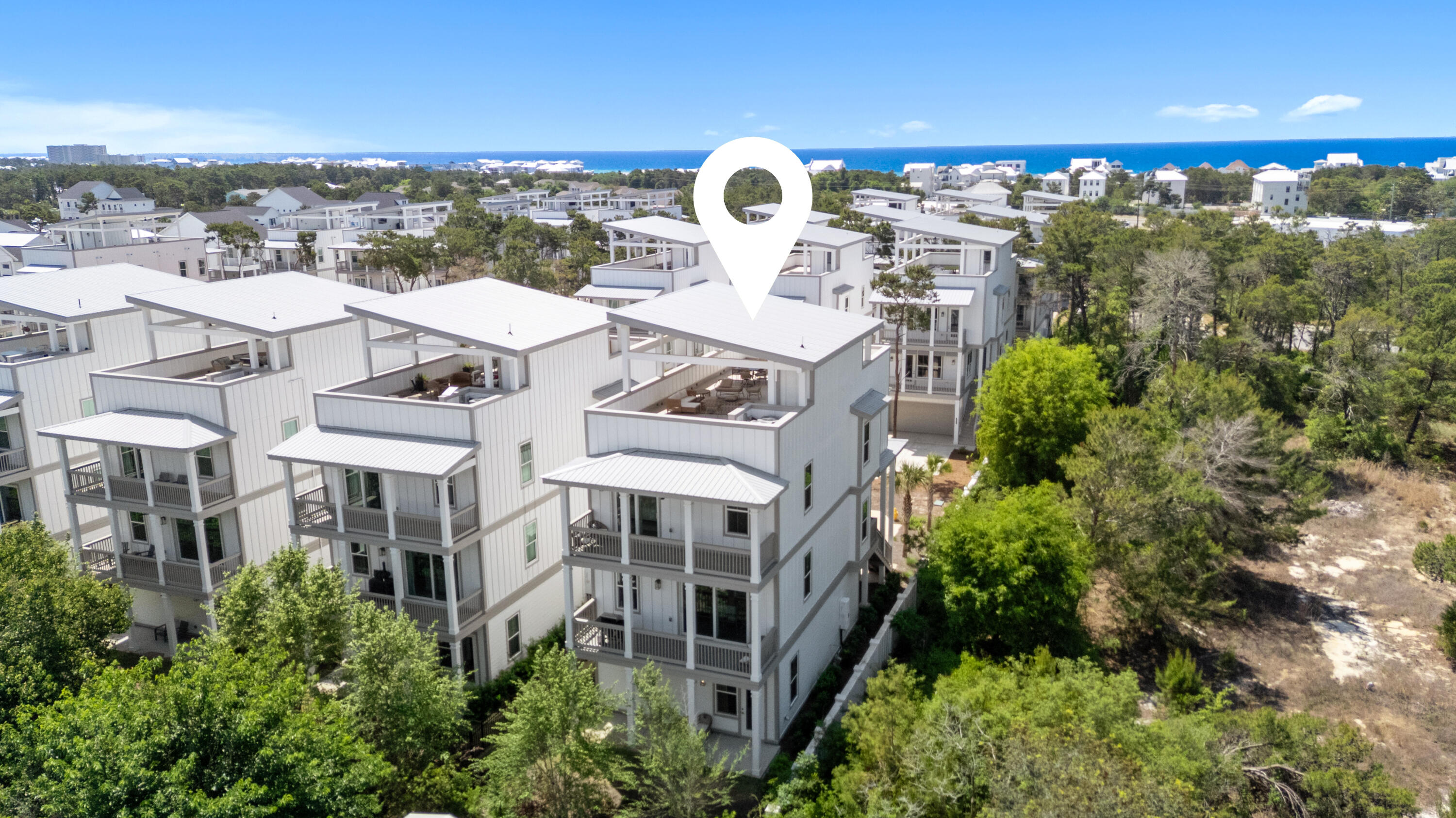 There is a certain energy to this stretch of Inlet Beach, where the rhythm of 30A meets the convenience of 30Avenue, and 28 W Queen Palm sits right in the center of it.

Set within the Twin Palms enclave, this four story Brock Built residence reads as both a refined coastal retreat and a strategic investment. Spanning four bedrooms and four and a half baths, the home was designed with intention, balancing livability with scale, and privacy with connection. An additional office offers flexibility for extended stays or remote work, while the overall layout lends itself seamlessly to both personal use and rental performance.

The main living level is open and inviting, anchored by a spacious kitchen and living area that naturally becomes the center of the home. Clean coastal lines, elevated finishes, and natural light define the interiors, creating a space that feels composed rather than overdesigned. Whether hosting a full house or a quiet weekend away, the flow is effortless.

Bedrooms are thoughtfully positioned, with one suite on the first level and three additional suites on the third, allowing for separation and comfort across multiple groups. Each space is designed with privacy in mind, offering en suite baths and a sense of retreat within the home itself.

Above it all, the rooftop terrace stretches the full length of the residence, and this is where the property truly distinguishes itself. It is expansive without feeling exposed, offering room to entertain, unwind, or simply take in the coastal setting. Gulf views, sunset light, and open sky create a setting that feels more aligned with a private club than a typical beach home.

Functionality has not been overlooked. An oversized garage accommodates both vehicles and golf cart storage, and the home is positioned for effortless access to 30A, the beach, and surrounding communities via bike or golf cart. The homesite has the potential to add a private plunge pool, further enhancing both lifestyle and rental appeal.

For those thinking beyond a single property, the opportunity becomes even more compelling. The same ownership is offering 34 W Majestic Palm just one street over, creating a rare chance to secure two homes within the same neighborhood, a strategy that is increasingly difficult to replicate along 30A.

At its core, 28 W Queen Palm is about access and ease. Access to dining, shopping, and the beach. Ease of ownership, whether as a second home or income producing asset. In a market where location and usability define long term value, this residence delivers both with quiet confidence.