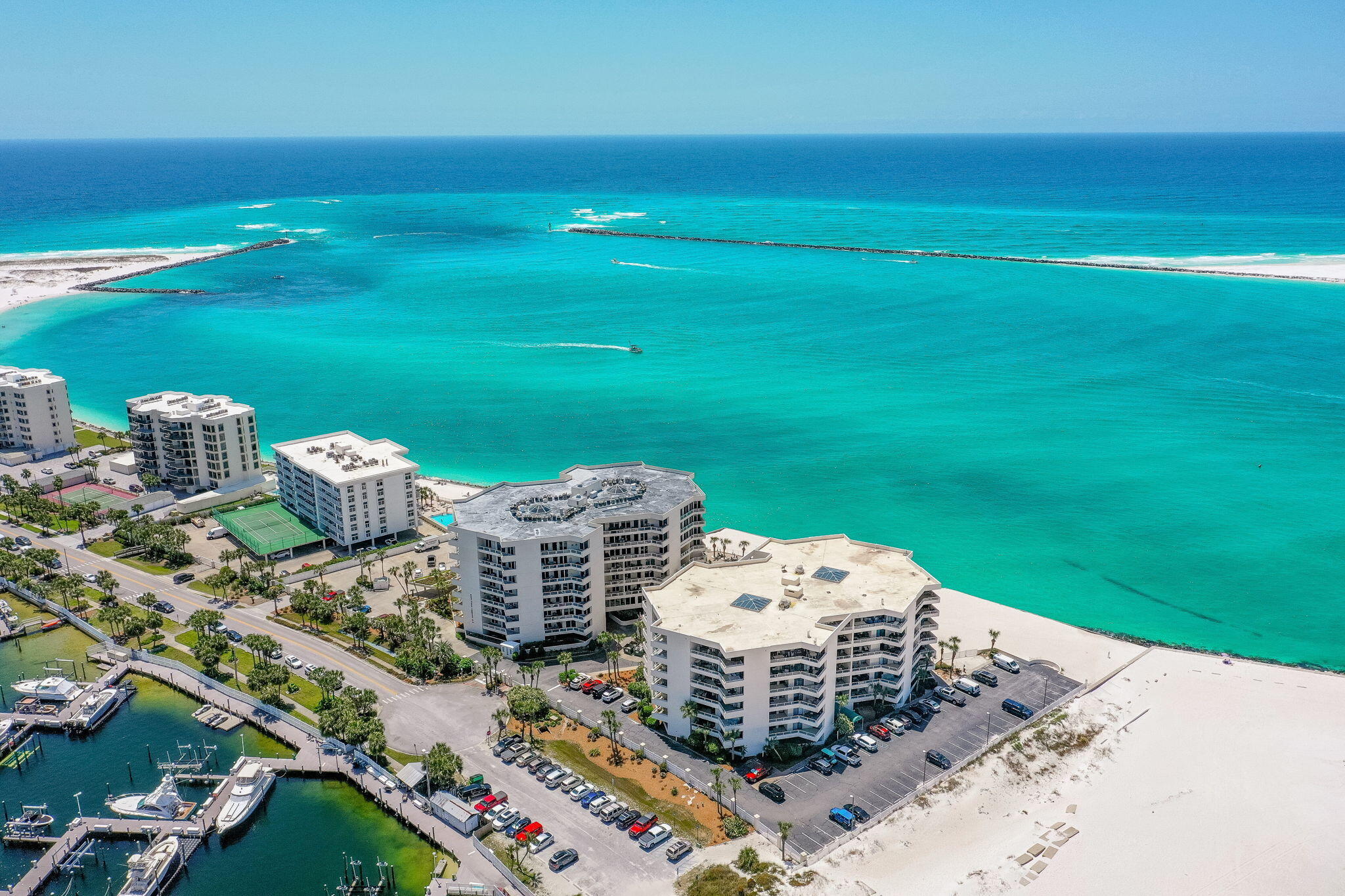PRICED TO SELL -- BEST-PRICED STR OPPORTUNITY AT EAST PASS! 

Luxury, location, water views, and value all come together at East Pass 208 on Destin's coveted Holiday Isle. If you have been waiting for the right Destin property, this is the one that deserves your attention. Beautifully updated, fully furnished, and positioned inside a private, gated waterfront community, this spacious 2-bedroom, 2-bath condo delivers incredible views of the beach, the Gulf, East Pass, Destin Harbor, and Crab Island--all from one of Destin's most desirable locations.

THE VIEWS ARE THE SHOWSTOPPER. Wake up to sparkling water views from both bedrooms and the living room, then step onto the covered balcony and watch boats cruise through the East Pass. With balcony access from nearly every room, this condo was designed around the waterfront lifestyle. From brilliant sunrises to unforgettable sunsets and seasonal fireworks over Destin Harbor, the scenery here never gets old.

Step inside and you are immediately greeted by an inviting coastal interior highlighted by brand-new sliding glass doors--an approximately $40,000+ upgrade--bringing the incredible waterfront backdrop right into the condo. The designer kitchen makes its own statement with endless granite countertops, storybook white cabinetry, stainless-steel appliances, custom glass-tile backsplash, and an oversized breakfast bar, creating an upscale centerpiece for entertaining.

The primary suite feels like a private waterfront retreat! It features a striking reclaimed-wood accent wall, direct balcony access, and a beautifully finished bath with a custom tiled shower, double vanity, and dedicated makeup area.

The second bedroom is another major standout, featuring newly installed custom-built bunk beds that maximize sleeping space while giving the room a polished, purpose-built coastal feel. Whether used as a vacation getaway or rental investment, this floor plan offers the space and flexibility buyers are searching for.

Major improvements have already been handled, including complete renovation, the new sliding glass doors, newer HVAC system, and new custom bunk beds. The condo is being offered fully furnished and turnkey, with five years of rental history available for buyers looking for an established vacation-rental opportunity.

And then there is the LOCATION.

East Pass sits inside the gated and private Holiday Isle community, offering a secure, upscale setting with plenty of parking while keeping you minutes from everything Destin has to offer. Step outside and enjoy direct beach access, or catch the Destin Harbor water taxi for an unforgettable ride to HarborWalk Village, AJ's, waterfront restaurants, entertainment, and nightlife.

East Pass Towers delivers the resort lifestyle with a beachfront pool, hot tub, two levels of waterfront sundecks, fitness room, lounging areas, and beach access just steps from the building. Holiday Isle itself feels like a hidden coastal oasis, with approximately 2.5 miles of paved roads and trails perfect for walking, biking, and exploring.

Want the beach? It's yours. Want boating, fishing, snorkeling, paddleboarding, parasailing, and the Destin Harbor lifestyle? It's all right here. The famous Destin Jetties--where the emerald waters of the Gulf meet the Harbor--are just a walk down the beach.

Best-priced unit at East Pass. Beautifully updated. New sliders. Newer HVAC. Custom-built bunks. Fully furnished. Incredible rental history. Gated community. Waterfront amenities. And views that simply cannot be duplicated.

PRICED TO SELL and ready for its next owner -- East Pass 208 is the Destin waterfront opportunity buyers have been waiting for.