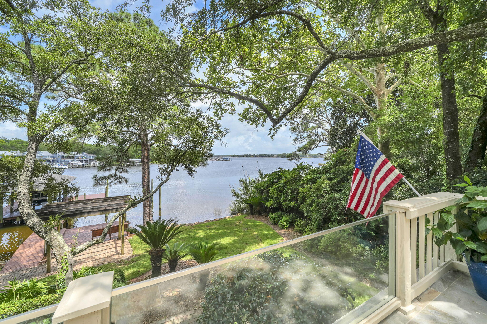 ONE OF A KIND Niceville waterfront home on the quiet shores of picturesque Swift Bayou with a main house, an attached apartment and a deep-water dock complete with a lift as well as offering 4 additional boat slips!! The 'main' home with 4 bedrooms and 2.5 baths has about 2985sf of living space with a large screened waterfront porch and deck. In 2022, two of the stalls of the 4-car garage were converted into a 1-bedroom apartment with a living area, kitchen, laundry facilities and a large bonus room above. This apartment is absolutely perfect for multi-generational living or could also be used as a very private home office or gym. The possibilities are endless! When you walk into the main house you are captivated by the 'wall of glass' offering beautiful views of Swift Bayou flowing out into Rocky Bayou. The living room is awash with light streaming in through the transom windows on the back wall. Just off of the living room is the dining room and the kitchen featuring a double-sided fireplace shared with the living room. The kitchen offers an abundance of cabinet and counter space as well as a large island that doubles as a breakfast bar. On the other side of the living room is the master bedroom suite. The master bedroom overlooks the water as well and there are sliding doors out to a private balcony that leads to the screened porch and deck. Beautiful barn doors separate the master bedroom from the master bath featuring two vanities and a large walk in shower. On the same side of the house, you will find an additional bedroom (currently used as a den) a convenient office and a half bath. On the opposite side of the house there are two large bedrooms that share a Jack-n-Jill bath. Through the 2-car garage on the same side of the house is one of the entrances to the apartment (there is also an entrance from the driveway). The 2022 built apartment has an open floorplan with a private bedroom and bath. Above this space is a large "bonus room" that could be an additional bedroom in the apartment. Along the back of the main house is a large screened porch and open deck, the perfect place for enjoying the amazing views of Swift Bayou and Rocky Bayou as well. A charming winding path leads to the dock and boathouse that was upgraded in 2022 with all new decking, stainless steel hardware new pilings where needed and protecting all the pilings with polywrap. If you are looking for space for all of your boat and water toys, you can find all the storage you need in an enclosed room under the balcony and deck! Your waterfront dreams start today in this amazing home...don't delay!! Practical notes regarding the "main house" - HVAC (2025), generator (2025), upgraded siding to cement board (2023), upgraded dock (2022), added apartment (2022), Water heater (2019).