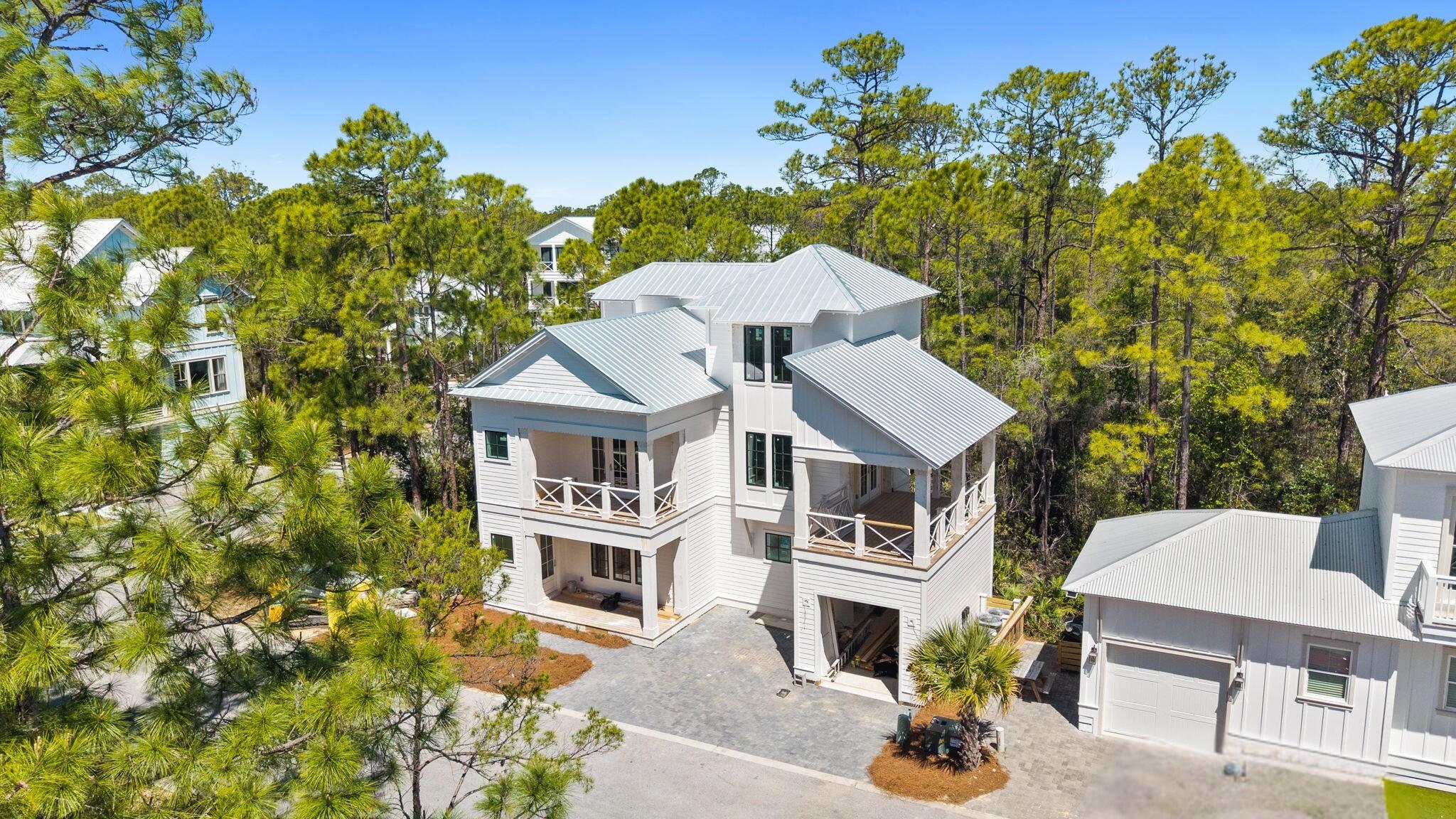 UNDER CONTRACT - ACCEPTING BACKUP OFFERS. A 2026 new construction three-story coastal home within the gated community of Treetop Village. Offering 4 bedrooms and 4.5 baths, this custom home features refined finishes and a thoughtfully designed floor plan. The main level features an open-concept layout where the kitchen, dining, and great room come together, enhanced by natural light and beam-accented details, along with a first-floor guest suite.

The second floor is centered around an additional living area that opens directly to an expansive covered porch, creating a natural extension of the interior and an ideal setting to relax or entertain. The primary suite is also located on this level, offering a well-appointed bath featuring a double vanity, soaking tub, and walk-in shower. An additional bedroom with its own private balcony completes the floor.

The third floor provides a bunk room and full bath, offering flexible space for guests and maximizing sleeping capacity. A one-car garage provides convenient parking and additional storage.
Treetop Village residents enjoy a heated community pool and private beach access with convenient tram service. Ideally nestled between Alys Beach and Rosemary Beach, this community offers dual gated entry to both 30A and Highway 98, providing quick access to Watersound Publix and Town Center, 30Avenue, and an array of dining and shopping options along the East end of 30A.
Estimated for completion in early summer, perfectly timed to take advantage of peak season rental demand. Don't miss the opportunity to secure this brand new coastal home, schedule your tour today.

All measurements to be verified by buyer.