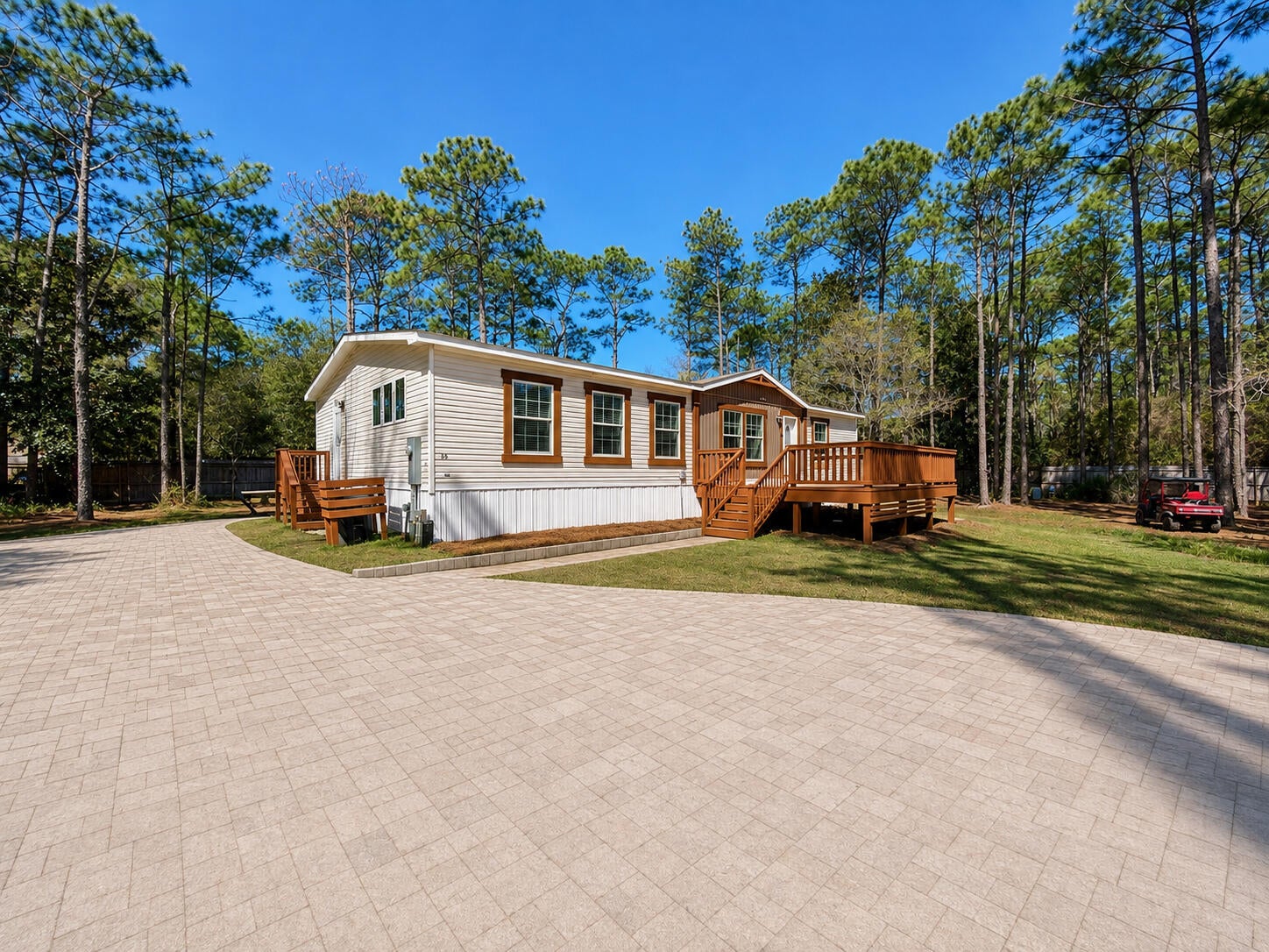 RARE ONE-ACRE RETREAT IN SANTA ROSA BEACH -- NO HOA, NEAR THE BAY & BEACHES! Discover a private, fully fenced one-acre homesite offering an exceptional combination of space, privacy, and coastal convenience. Located just one block from Choctawhatchee Bay and directly across from Point Washington State Forest, this property puts nature, boating, and the beach lifestyle within easy reach.

Built in 2022, this beautifully updated 3-bedroom, 2-bath manufactured home features a bright contemporary interior, open living spaces, and a spacious front deck perfect for relaxing or entertaining. The home is permanently affixed, converted to real property with a retired title, and supported by an engineered foundation system with concrete footings, CMU piers, and steel beam support.

The paved driveway offers plenty of room for multiple vehicles, boats, trailers, or an RV. With one full acre and NO HOA, the large private yard provides excellent flexibility for a future pool, workshop, detached garage, storage, gardens, or additional outdoor living.

Just minutes from the white-sand beaches of South Walton, 30A, shopping, dining, and bay access for boating, fishing, kayaking, and paddleboarding. AT&T Fiber Internet is available.

One acre, newer construction, no HOA, fully fenced, paved driveway, privacy, and an outstanding Santa Rosa Beach location!