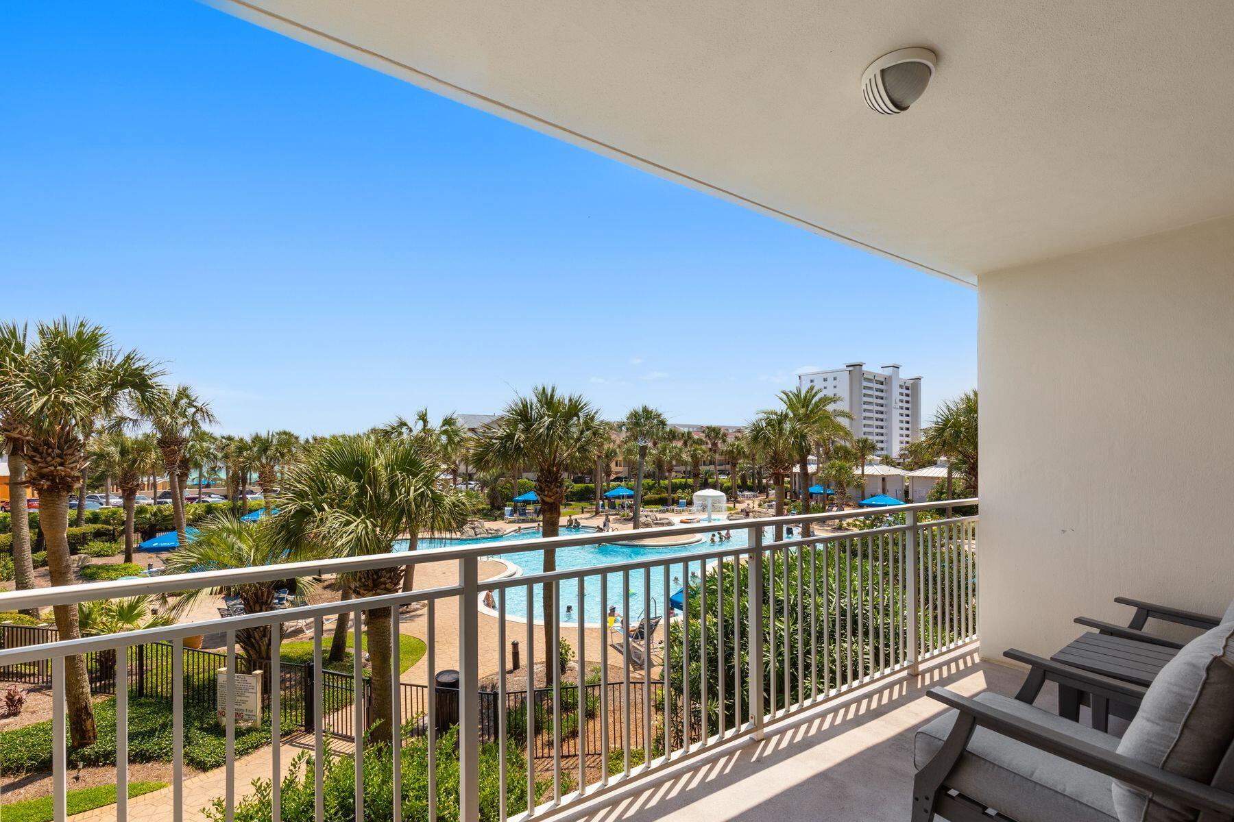 Located within the gated, eight-acre Sterling Shores, this updated one-bedroom, one-bath second-floor condo is ideally positioned in the heart of Destin, just across from The Track and minutes from HarborWalk Village, Crab Island, and some of the area's most popular dining and entertainment.

Inside, the unit has been thoughtfully updated with a coastal aesthetic and is fully furnished and rental-ready. A tiled entry leads to a well-appointed C-shaped kitchen featuring stainless steel appliances, white cabinetry, pantry storage, and an oversized breakfast bar that comfortably seats four. The open living area is filled with natural light and opens through a wall of sliders to a private balcony overlooking lush landscaping, lighted pathways, and peek-a-boo Gulf views.

The bedroom features a king bed with LVP flooring, while the bathroom includes a cultured marble vanity and jetted garden tub. A stacked washer and dryer is conveniently tucked in the hallway, and the unit includes a rare owner's storage locker on the first floor.

Sterling Shores offers resort-style amenities including a beachfront pool with café, a secondary resort pool, fitness center, private theater, grilling areas, and deeded beach access via a scenic boardwalk over the dunes, placing the Gulf's white sand just steps away.