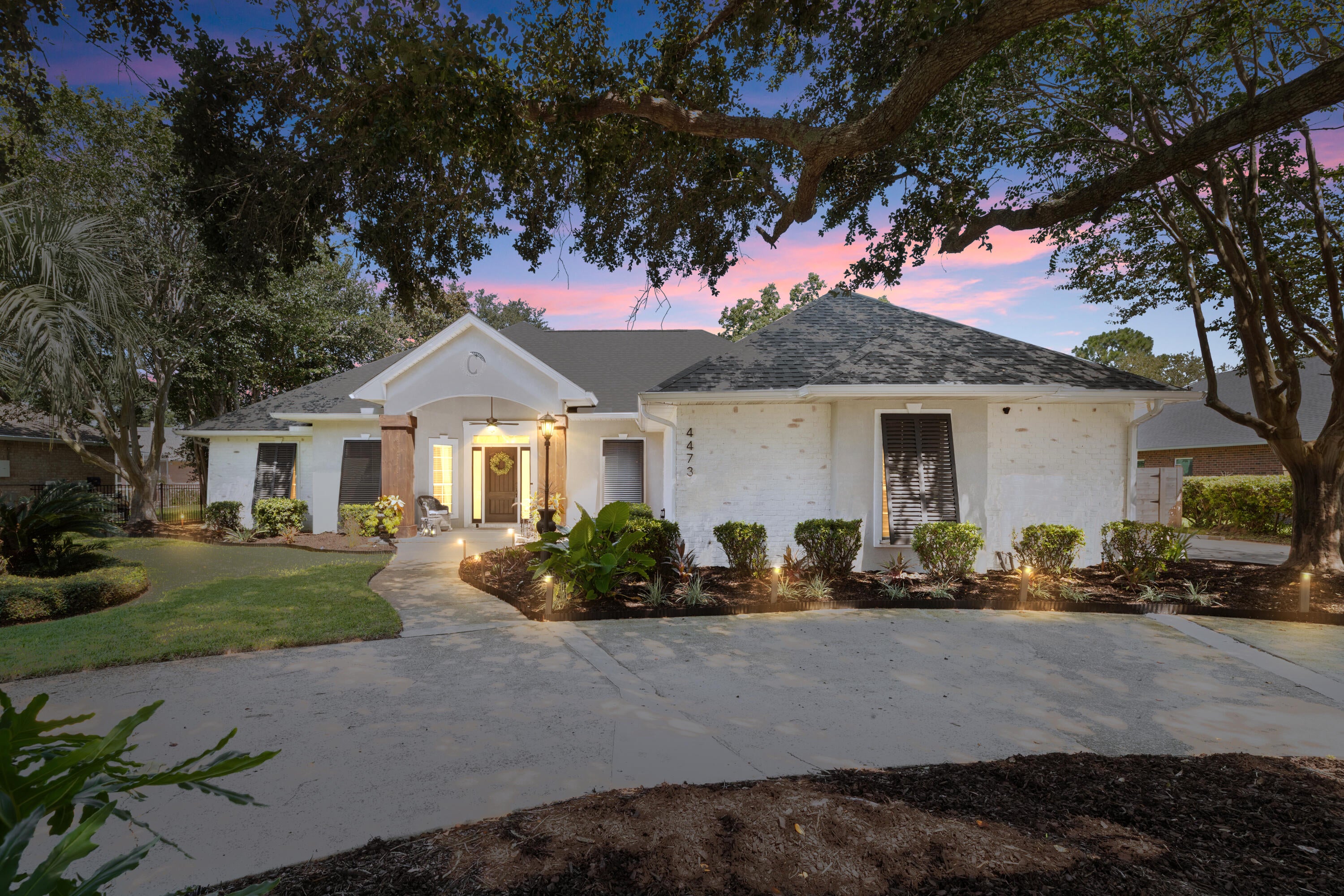 Turnkey Tiger Point living with the updates already done and an outdoor space designed for the Florida lifestyle! This extensively updated brick home offers a heated pool, outdoor grill entertainment covered area, flexible guest suite and boat/jet-ski parking--all within walking distance to park and minutes to Americas best beaches! Updated throughout the past year with new flooring, fresh paint, cabinetry and plumbing fixtures, lighting, remote-controlled fans and designer accent walls. The inviting living area is anchored by a classic brick fireplace and features plantation shutters and blinds. No carpet and no popcorn ceilings! The primary suite includes double closets and a spa-inspired bath with soaking tub, separate shower, bidet and private water closet. A second primary-sized bedroom offers its own full bath and exterior entrance directly to the pool and backyard--ideal for guests or multi-generational living. A bonus room, half bath and 9'x32' heated/cooled sunroom with custom built-ins add even more flexibility. The updated kitchen features a gas cooktop and oven, stainless appliances, wine cooler, pantry and lighted built-ins. Outside is where this home truly shines. The private backyard features a heated pool upgraded in 2026 with new liner and gas heater, Zoysia sod, fresh landscaping and new privacy fencing. A 14'x24' powered gazebo creates an incredible entertaining space with outdoor kitchen, built-in grill, smoker and boiler, fans, TV and firepit seating..... A gated concrete pad provides dedicated parking for a boat or jet skis. Additional highlights include a 2021 roof, whole-house RainSoft filtration, hurricane shutters, security wiring, generator plumbing, mature citrus trees, and circle and side drives. Close to highly rated schools, healthcare, shopping, dining and boat-launch access!