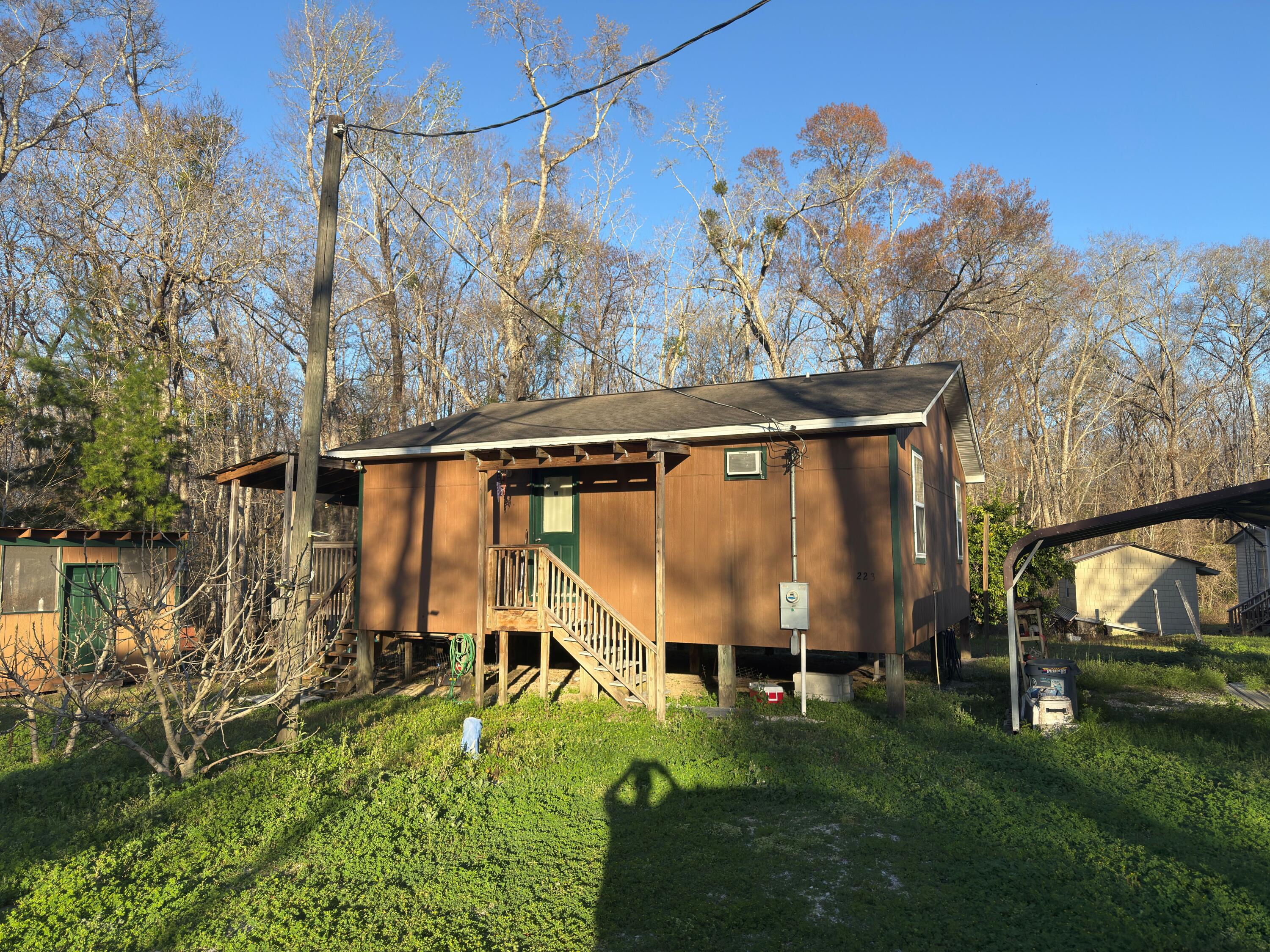Turn Key cabin that is furnished less than 1500 feet from Bryant's Landing. Enjoy easy access to the Chipola River which is one of North Florida's truly remarkable ecosystems. Cabin is very spacious and is an open plan consisting of 2 bedrooms and 1 bath. Kitchen and dining area that open onto a screened porch suitable for enjoying the morning coffee or afternoon breezes. Plenty of closet space in the main living area as well as the bedrooms. Property also has covered parking as well as two additional storage rooms. Currently water and sewer are community owned and the annual fee is $600.00 for both. No HOA and only Gulf County restrictions. Less than 10 minutes to Wewahitchka, Only 20 minutes to Port St Joe, and about 25 minutes to Mexico Beach. Don't let this sportsman's paradise gem
