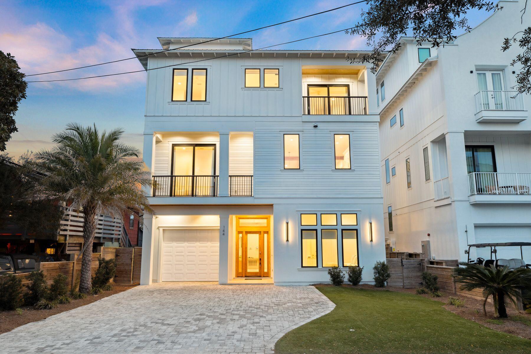 Some beach houses are simply places to sleep between beach visits; this one is the destination itself. Completed in 2021, this four-story, sleek coastal contemporary in Frangista Beach is the ultimate expression of Gulf Coast living - eight bedrooms, eight ensuite baths, and a visionary layout that wraps breathtaking views around every gathering space, every private balcony, every quiet morning moment. Soaring beamed ceilings, 24'×48' tile floors, and floor-to-ceiling slider doors create a sense of openness that feels as boundless as the water beyond. The sophisticated second-floor living room drinks in natural light through picture windows, while the all-white chef's kitchen - with Fisher & Paykel appliances, a gas range, a wine cooler, and a glittering quartz island - invites long, leisurely meals that stretch well into the evening. Below, the ground-floor game room sets the tone for pure fun: pool table, a sleek wet bar, and doors that spill directly onto the pool deck. Here, a resort-style pool and hot tub shimmer within a privacy-fenced backyard, flanked by an outdoor kitchen and lounge built for golden-hour entertaining. And above it all, the rooftop terrace with gulf views - part covered retreat, part open-air perch - offers an outdoor kitchen, a crackling fire pit, and the kind of sunsets that make guests lose track of time entirely. With accommodations for up to 18 guests across six king beds, four queen beds, and six twin bunks, a 3-stop private elevator, two two laundry sets, and a garage perfectly sized for a car or golf cart, every logistical detail has been quietly solved. Gated beach access for Frangista Beach at Hollywood Street is just a short stroll away, with fine dining, coffee shops, ice cream parlors and boutique shopping minutes down Scenic 98. Recently refreshed, fully furnished and ready for its next chapter.