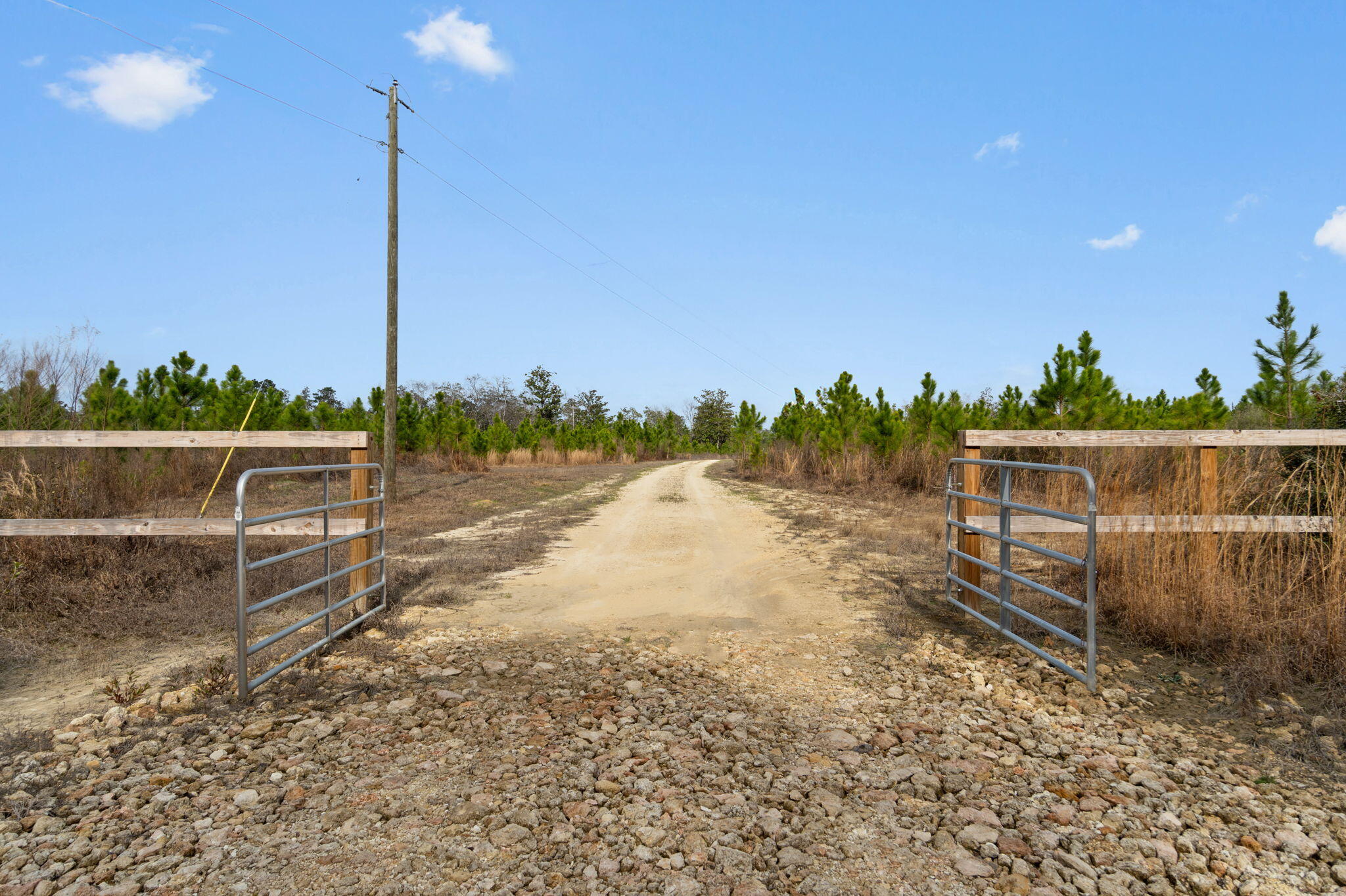 Set on 81 acres of beautifully cleared countryside, the barndominium at 1133 Show Horse Way in Laurel Hill, Florida offers a rare blend of privacy, space, and authentic rural charm. Surrounded by the rolling beauty of Walton County's scenic landscape, this property feels like a retreat from the everyday--open skies, peaceful pastures, and long views that stretch for acres. Whether you envision horses grazing, weekend gatherings, or simply room to breathe, the land provides endless possibilities while still capturing the simplicity and serenity that makes North Florida so desirable. A picturesque creek with a white-sand bottom winds its way out of sight, at the end of Show Horse Way, adding a natural focal point that feels straight out of old Florida. All information provided herein, including but not limited to square footage, room dimensions, lot size, features, and amenities, is deemed reliable but not guaranteed. Buyers are strongly encouraged to independently verify all details and conduct any inspections or measurements necessary to determine the accuracy and suitability of the property for their intended use. Neither the seller nor the listing agent assumes responsibility for errors, omissions, or misstatements