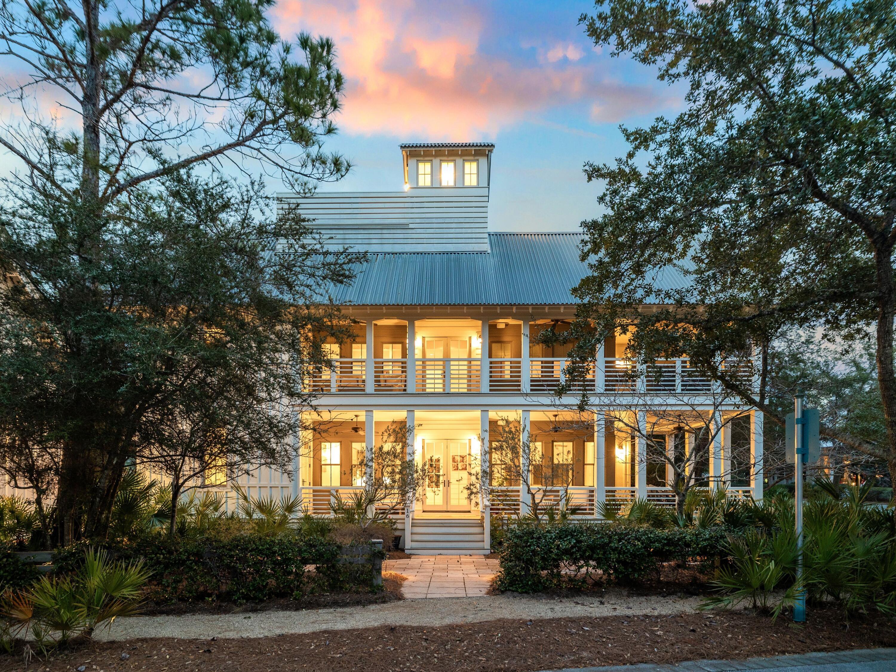 Currently under contract with a kick-out clause, this exceptional property remains available for qualified buyers seeking a rare opportunity. In the heart of WaterColor's Lake District, this distinctive High Street residence is one of only four signature homes originally built by St. Joe--a rare architectural pedigree that sets it apart within one of 30A's most sought-after communities. Positioned on a private corner homesite overlooking protected parkland, the home offers exceptional privacy, timeless craftsmanship, and enduring value.

Spanning more than 4,000 square feet, the thoughtfully designed floor plan features five bedrooms, five baths, and a detached carriage house above the two-car garage with its own private entrance and full bath, offering exceptional flexibility for guests, a home office, or extended stays. The generous homesite also provides room to add a private pool. Thoughtfully refreshed in 2025 with all-new furnishings and curated interior finishes, the residence presents a beautifully updated aesthetic while honoring its timeless architectural character. A welcoming wraparound porch leads to interiors filled with natural light, soaring vaulted ceilings, and an effortless flow for everyday living and entertaining. The main level centers on an inviting living area with a custom bar, opening to a well-appointed kitchen appointed with Viking appliances and abundant cabinetry. A guest suite with a full bath and a spacious laundry room completes the first floor.

Upstairs, three en-suite bedrooms provide comfort and privacy, while the third floor offers a light-filled loft retreat complete with a wet bar, custom built-ins, and a crow's-nest tower showcasing elevated treetop views and an ideal vantage point for enjoying sunset skies. The detached carriage house further enhances the home's versatility, making it equally suited for hosting family and friends or creating a private workspace.

Just moments from Frog Pool, the Lake Forest footbridge, and the WaterColor Beach Club, residents enjoy convenient access to resort-style pools, parks, playgrounds, tennis courts, scenic nature trails, and the sugar-white beaches of the Gulf. Combining architectural significance, an exceptional location, and a highly functional floor plan, this is a rare opportunity to own one of WaterColor's truly signature homes.