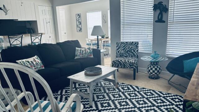 Affordable Condo in heart of Destin.  Great location across from beach.  Great to live in, long term or vacation rental.  Nice Beachy decor.  Very spacious 1 bedroom unit.  Close to everything. Sold fully furnished. 3 pools on property, tennis Courts, lakes, pretty area.
Condo at front of Complex and on the first floor. Very convenient.