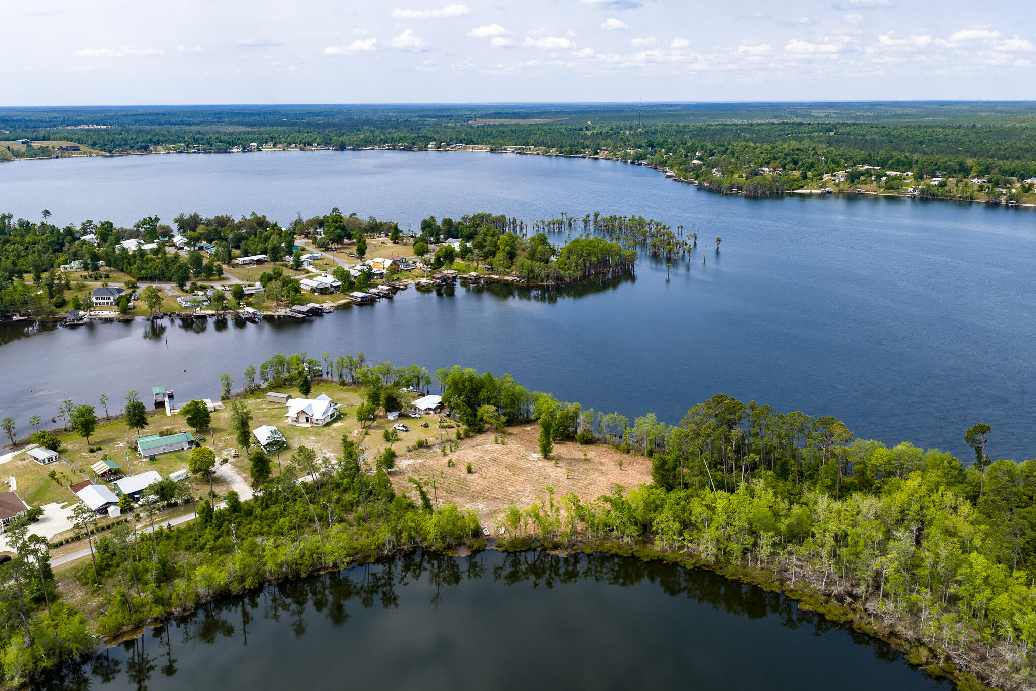 Welcome to the perfect waterfront retreat on the pristine shores of Compass Lake! This beautifully cleared ±1.6 acre lot boasts 200 feet of waterfront on Compass Lake with a gentle slope leading to a level entry, making it ideal for swimming, sunbathing, and enjoying the breathtaking lake views. The rear of the property features 100 feet of waterfront on Black Pond that's filled with bass, bream, and blue gill fish. Slight south west orientation great for sunsets and summer breeze. With direct access to the crystal-clear waters, this property is perfect for boating, fishing, sailing, and water sports. 

Compass Lake is an expansive, 600-acre spring-fed lake located 35 miles north of Panama City Beach, and it's crystal-clear waters and scenic views make it a local favorite for relaxation and recreation. Outdoor enthusiast who enjoy hiking, cycling, and wildlife observation in the surrounding pine forests and rolling hills find this region to be paradise.