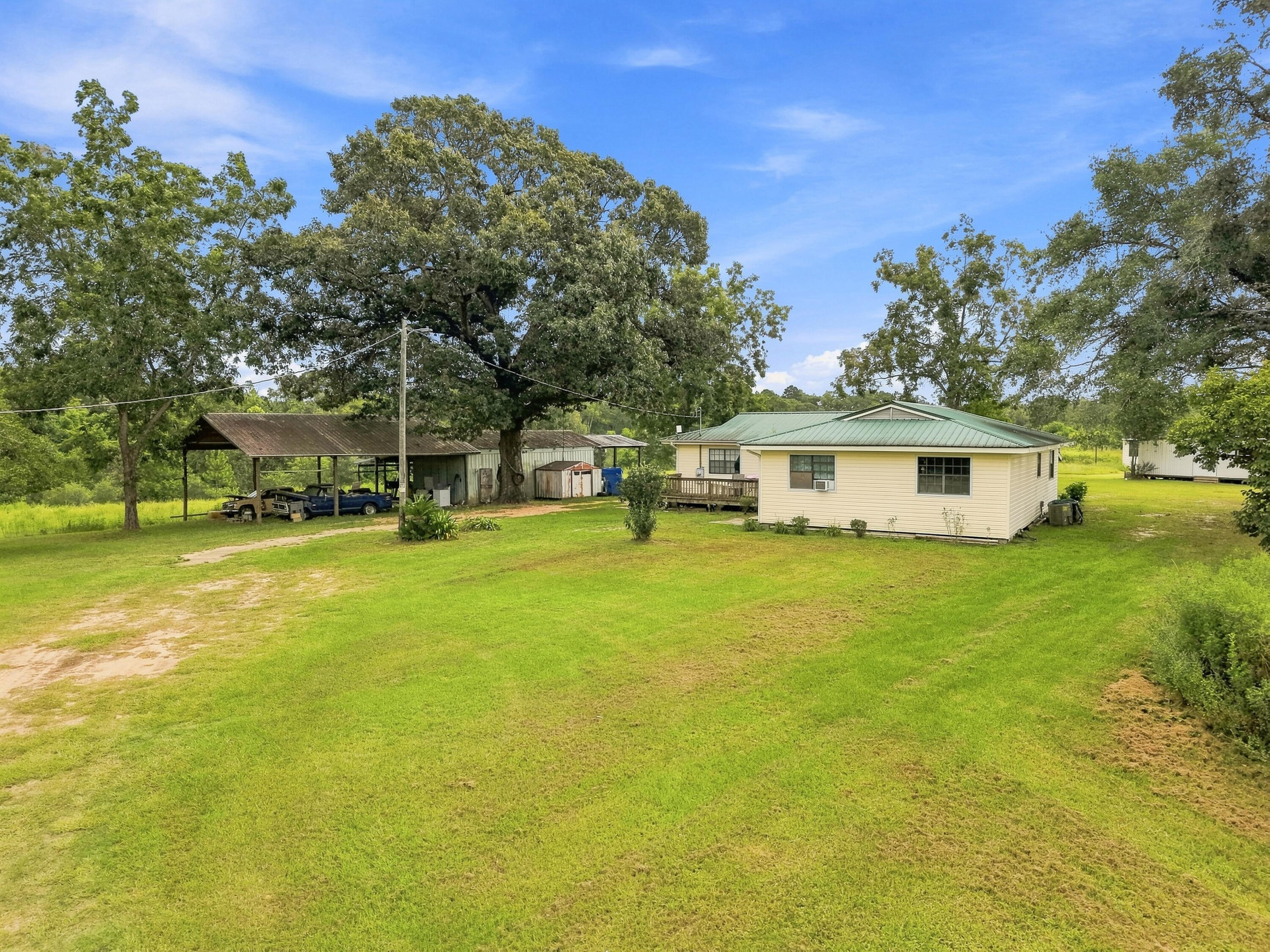 Looking for some land in North Walton County with pasture, barns, and creek? This 18.56 acres has everything on your check list!!!! Located on property is a 4-bedroom, 2 bath 2592 total sqft home with living room, kitchen, and dining. Home also includes a large back porch and front deck.  Property has a well, septic, and power along with 2 separate storage buildings and a large open barn with enclosed work area. Property has a natural flowing creek as well as wooded areas and makes for a perfect hunting retreat or your retirement plan dream. Located in North Walton - one of the most desired locations! House is priced with the knowledge of home needing repairs. Conventional financing only.