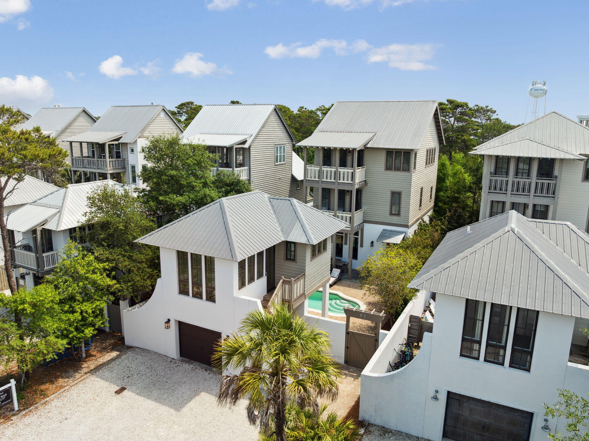 Exceptional location, tucked in a residential area between two of 30A's premier luxury shopping areas. This beautifully built and designed home comes with all the convenience of being right where you want to be, without the worry of an association.  A three-story coastal residence -with a detached carriage house and private courtyard pool- captures the essence of elevated beachside living and is just down the way from a nearby beach access. Spanning nearly 3,000 square feet, the home offers five bedrooms and five-and-a-half baths, perfect for entertaining and everyday escapes.