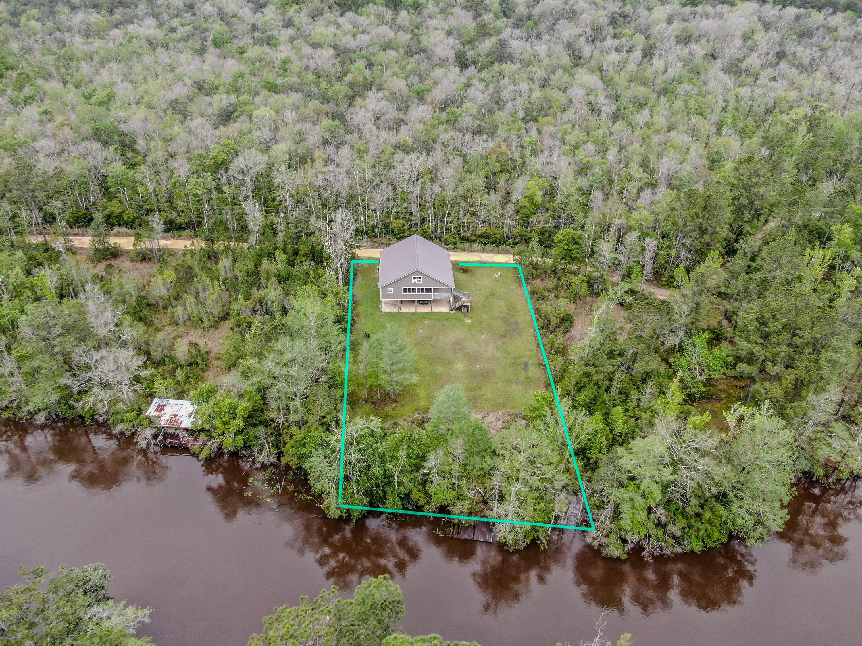 Discover your private waterfront sanctuary on serene Alaqua Creek in beautiful Freeport, Florida. This exceptional elevated home at 264 Johns Lane blends modern comfort with generous outdoor space on a spacious private lot with direct creek access and mature trees--perfect for privacy and Florida Panhandle living.
The thoughtfully updated interior offers approximately 2,918 square feet. The open main floor features a stunning kitchen with white shaker cabinetry, granite countertops, and a distinctive statement range. A spacious living area with cozy fireplace flows to expansive porches and a large screened patio overlooking peaceful woods and creek views.
Upstairs, a massive vaulted bonus room provides incredible versatility for a home gym, playroom, media lounge, or guest quarters. Four comfortable bedrooms and two well-appointed bathrooms include a fun-themed children's room and charming nursery.
Outside, enjoy a large cleared grassy area ideal for recreation and outdoor activities, plus direct Alaqua Creek access perfect for fishing and kayaking. The open lower level of the home provides covered parking and storage space, while mature trees ensure privacy and a tranquil setting.
Conveniently located on a private road yet near pristine beaches, shopping, dining, and excellent schools in growing Walton County, this move-in-ready waterfront retreat delivers peaceful seclusion with easy Emerald Coast access. Schedule your private tour today!