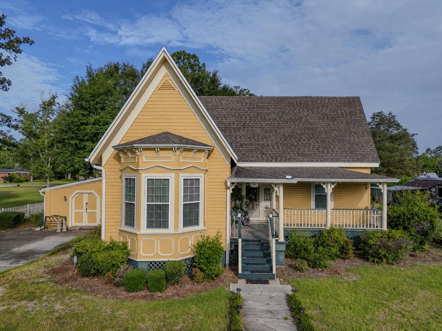 Nestled beneath the live oak canopy of Chipley's coveted South Third Street Historic District, this 1915 Queen Anne Victorian cottage is a rare find. While it is wrapped in timeless, vernacular architectural character, the home underwent a complete, top-to-bottom renovation in 1999 and has been meticulously maintained ever since. Enjoy structural confidence with a new 2019 roof (post-Hurricane Michael), updated plumbing, and high-efficiency blown-in attic insulation. Step inside a floor plan designed for connection; you just know this is where families have gathered! The well-laid-out kitchen flows seamlessly into living spaces anchored by four stunning, working fireplaces. The layout features two spacious bedrooms, two full baths, a dedicated private office, and an oversized laundry room with abundant storage. Outside, the property boasts the deep roots of a former ''Yard of the Month'' winner, offering incredible landscaping bones, mature greenery, and functional storage sheds. As the estate is being cleared, this historic gem is being prepared for its next chapter--contact your Realtor today to schedule your private tour!