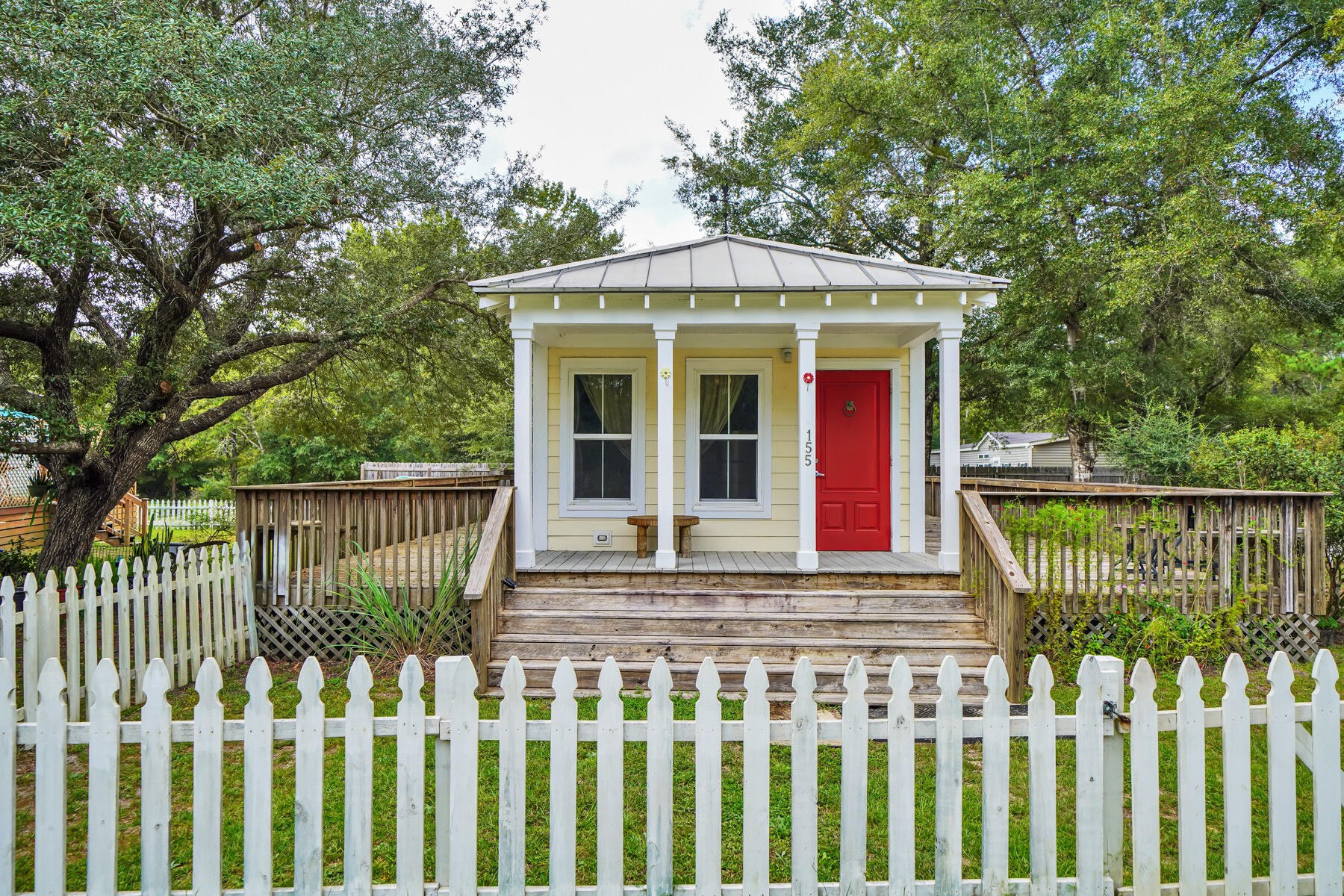 Adorable Florida Cottage with an expansive open deck wrapping around 3 sides of the home. Featuring crown mounding, granite countertops, and LVP flooring. Built strong to withstand 165 mph winds, with double-pane windows, metal roof, Hardie board siding, extra insulation for energy efficiency. The home has been part of a rental portfolio generating $1595.00 monthly. Enjoy a larger yard (approx 1/4 acre), or build on the adjoining lot, all tap fees are paid!