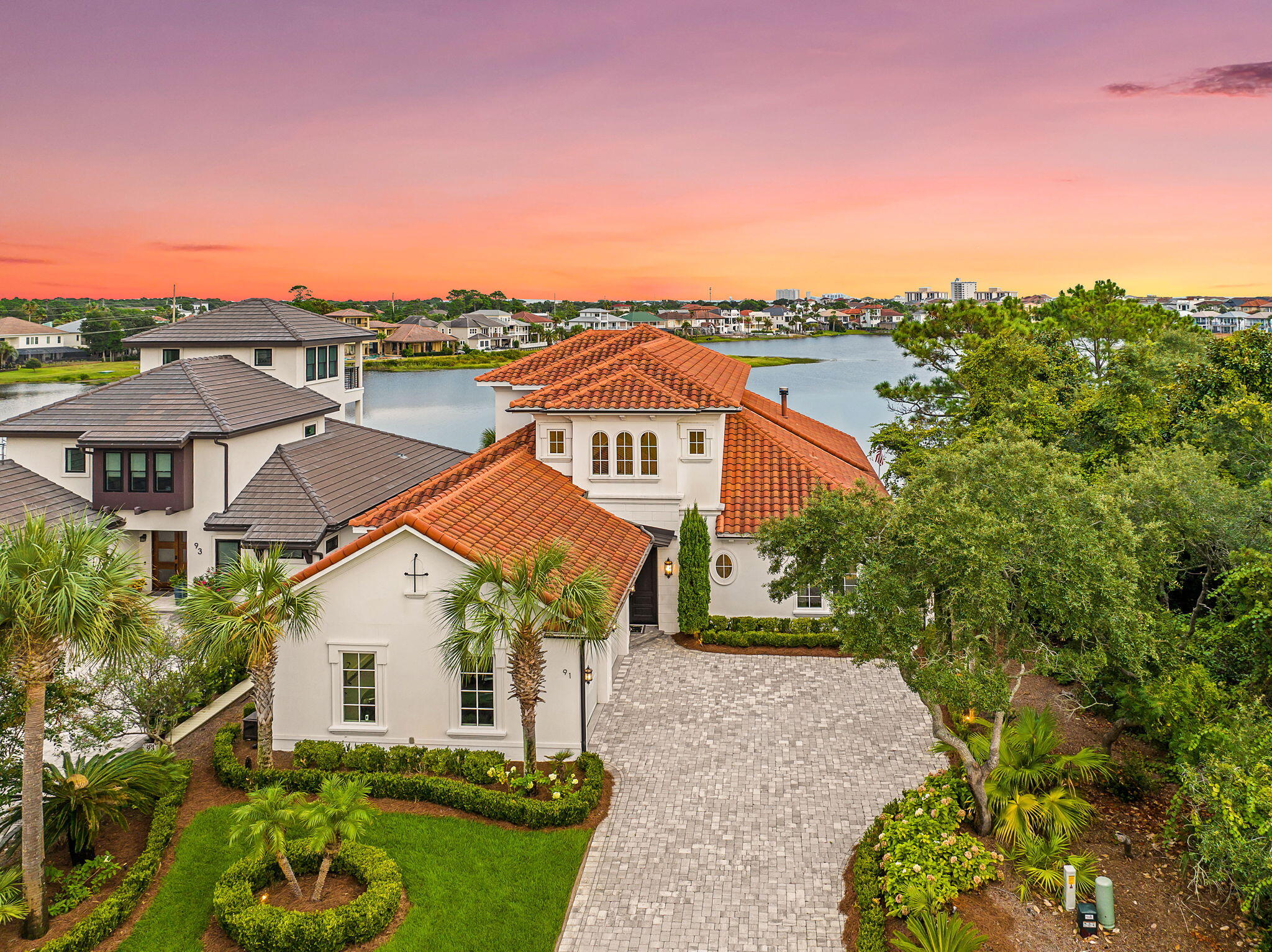 A commanding waterfront estate in the heart of Destiny West, 91 Vista Bluffs pairs an extraordinary setting with the scale, privacy, and craftsmanship expected of a true Destin trophy property. Set along the largest lake within the community, the residence is positioned to capture a remarkable view corridor stretching across the water toward the Gulf. It is a setting that immediately separates this home from the rest, offering a sense of openness and tranquility while remaining just minutes from Destin's white-sand beaches, boating, dining, and entertainment.

Every element of the residence has been considered with intention. The interiors are refined yet inviting, with exceptional finishes, custom details, and a thoughtfully designed floor plan that transitions seamlessly from everyday living to large-scale entertaining. The home has been meticulously maintained, preserving the quality and integrity of its construction throughout.

Outside, the property takes on the feel of a private resort. Expansive terraces frame a dramatic pool and hot tub overlooking the lake, creating an effortless connection between the home and its waterfront setting. Lush landscaping and carefully placed architectural lighting transform the exterior after sunset, making evenings here every bit as memorable as the daytime views.

Behind the secured gates of Destiny West, owners enjoy access to an exclusive collection of community amenities while remaining close to everything that makes Destin one of the most sought-after destinations on the Gulf Coast.

Rarely does a property offer this combination of waterfront positioning, Gulf views, privacy, and enduring quality. 91 Vista Bluffs is an estate designed to be experienced, not simply seen.

Private showings by appointment only with advance notice. Listing agent must accompany all showings.