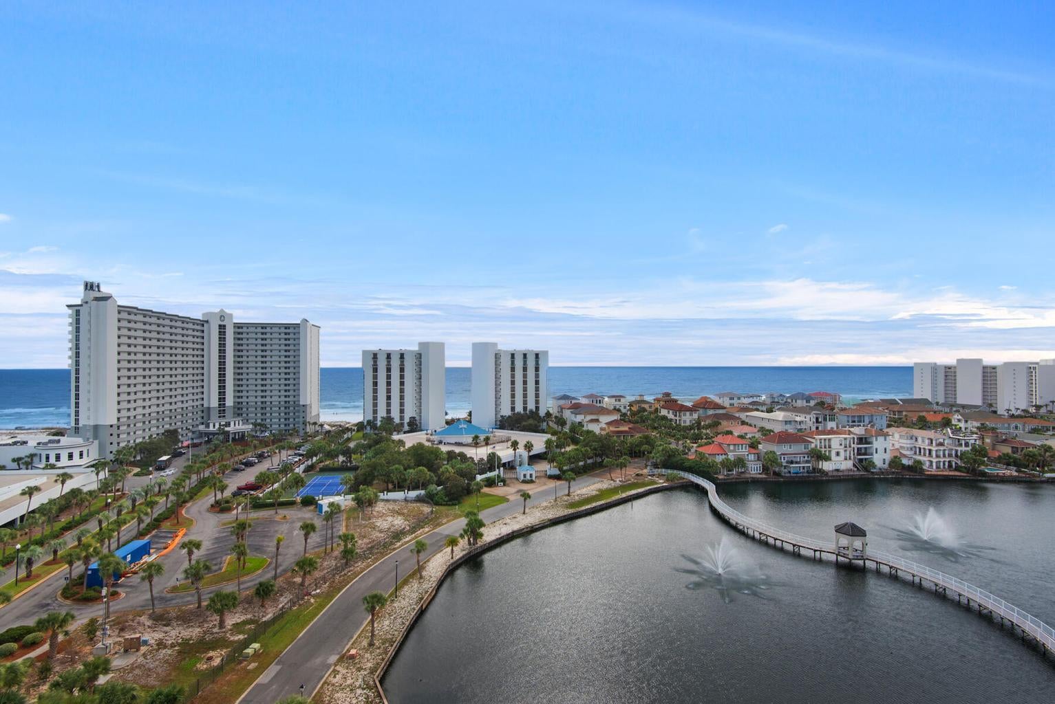Discover the epitome of luxury in the stunning 11th floor upgraded corner 3 bedroom 3 bath unit with wrap around balcony, offering breathtaking, panoramic views of Destin, the gulf, and coastal lakes. Enjoy front-row seats to stunning sunsets and dazzling weekly seasonal firework displays. This rare gem also includes a deeded covered parking space. Perfectly positioned in the heart of Destin, you are mere steps away from the vibrant Destin Harbor. This exceptional unit showcases numerous upgrades, including elegant vinyl flooring throughout, sleek quartz countertops, and custom designer furnishings. The bathrooms have been remodeled with premium Bath Fitter installations. The open-concept kitchen, dining, and living areas create an expansive setting ideal for family gatherings and upscale entertaining. Effortlessly transition between indoor and outdoor living as sliding glass doors connect the living room and master suite to the balcony, offering unparalleled views. The third bedroom provides additional privacy and versatility, featuring a kitchenette with a microwave, refrigerator, sink, a private balcony, and a full bath. Convenience is further highlighted with a stackable washer and dryer, a pantry, and an owner's closet for extra storage. Located within one of the Emerald Coast's most sought-after vacation complexes, this guard-gated resort boasts an impressive array of amenities. Beyond the numerous on-site features, owners and guests also enjoy exclusive access to the facilities at Pelican Beach Resort, enhancing their recreational and leisure options. Bask in a sun-soaked beach day on the private beach, meticulously maintained by Pelican Beach Resort, just a 5-minute walk along a scenic boardwalk from The Terrace. Stay active on the tennis courts or in the well-equipped gym, unwind at the Tiki Bar, or rejuvenate in the hot tub or steam room. Cool off in one of several pools, including the stunning 114-foot zero-entry pool. Find tranquility in the sauna or spark some fun in the game room. For even more excitement, Big Kahuna's Water Park is conveniently located just across the street, while Destin's finest attractions, shopping, dining, and vibrant nightlife are mere moments away. Perfect as a primary residence, second home, or a lucrative vacation rental, this turnkey unit, with its thoughtful upgrades, is ready for your next luxurious chapter.