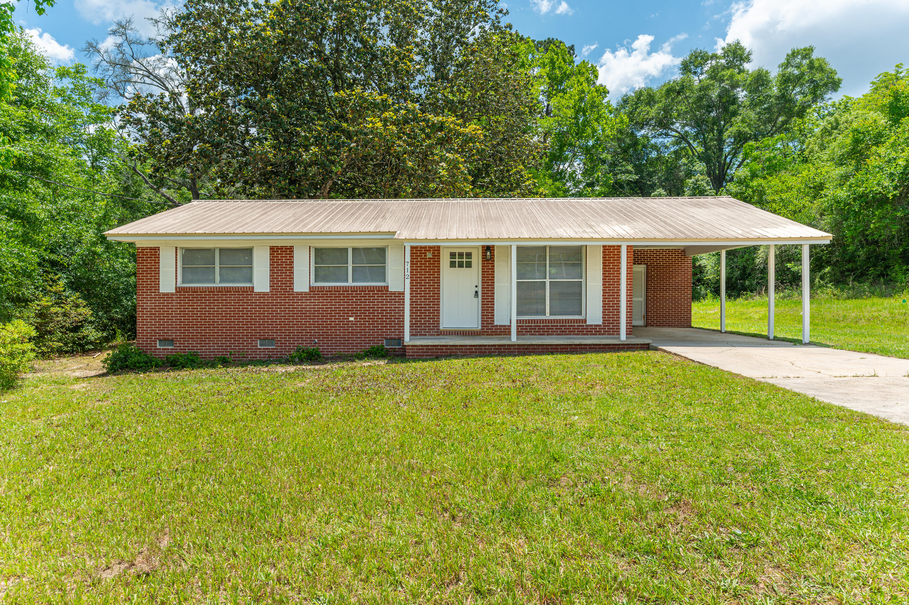 Right in the heart of DeFuniak Springs, this adorable 3 bedroom, 2 bath brick home gives you the perfect mix of convenience, charm, and comfortable living. Located directly across from Walton Middle School and just minutes from Lake DeFuniak, downtown shops, local restaurants, and year round community events, you are truly close to everything that makes this town special.
Inside offers approximately 1,040 square feet with a layout that feels cozy, functional, and easy to make your own. Outside, the spacious quarter acre lot gives you room to relax, entertain, garden, or simply enjoy your own outdoor space. The mature magnolia tree adds timeless Southern character you just cannot recreate. Whether you love peaceful mornings on the porch, evenings downtown, or the convenience of being centrally located without giving up that small town atmosphere, this home checks all the boxes. Add in the durability of a metal roof, an established neighborhood, and an affordable price point, and this becomes the kind of rental that is hard to find and even harder to leave. Cute, convenient, full of character, and ready for someone to call it home. Application requirements: 600+ credit score, one year consistent employment and household monthly income to be 2.5x the lease amount. Background check and credit check required.
