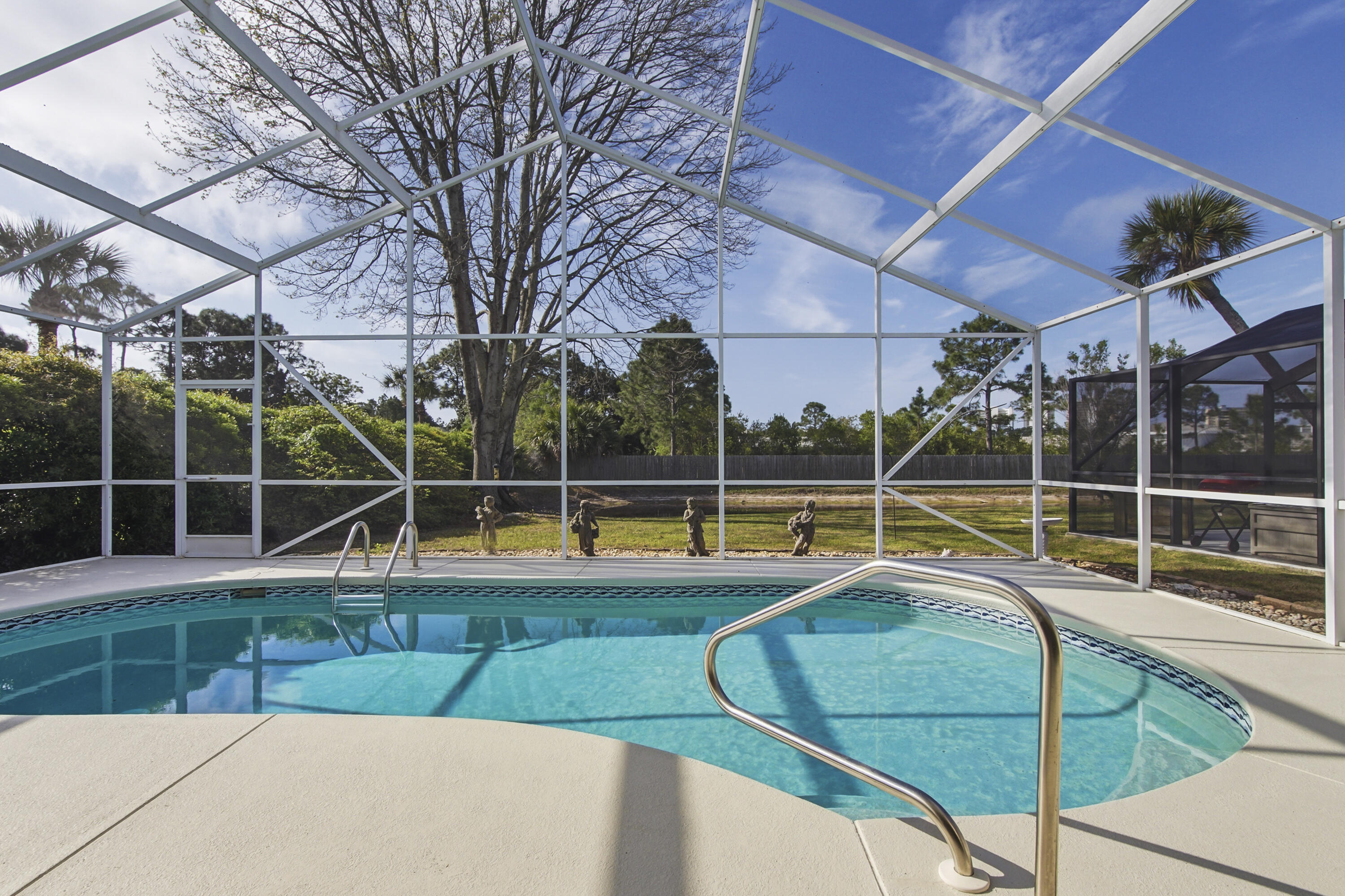 Welcome to your slice of paradise in The Glades! Ideally located just minutes from the white-sand beaches of Panama City Beach, this beautifully situated home offers the perfect blend of convenience and relaxation--only a short drive to popular attractions like Duplin Winery, shopping, dining, and entertainment. Inside, you'll find a bright and inviting open-concept kitchen and living area, perfect for entertaining or everyday living. The seamless layout creates a spacious feel with plenty of natural light. Step outside to your private retreat featuring a screened-in pool overlooking a peaceful pond, offering serene water views and added privacy. Whether you're enjoying your morning coffee or hosting guests, this outdoor space is designed for true Florida living. Don't miss this opportunity to own a home in one of Panama City Beach's most desirable communities--close to the beach, yet tucked away in a quiet, scenic setting.