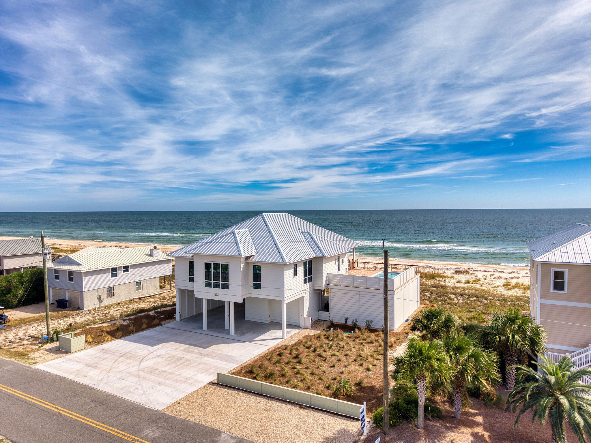 This new construction, six-bedroom, six-bathroom Gulf-front home is custom-built with large families in mind, incorporating thoughtful details that both owners and renters will appreciate. The ground floor heated and cooled entry foyer takes you to the main living level via an elevator. The main living level is designed for spacious group stays, featuring everything in pairs to avoid feeling crowded. You'll find two Gulf-front primary suites, each with walk-in closets and large master bathrooms. Additionally, there are two king-bed junior suites and two bunk rooms. To provide separate spaces for different age groups, the home includes two distinct living areas: one overlooking the Gulf and another situated near the bunk rooms. The kitchen is equipped with two French-door refrigerators, two dishwashers, a double oven, and ample cabinetry. Laundry is made easy with two dryers and one washer. The interior décor is both stylish and durable, featuring quartz countertops, LVT flooring throughout, beautifully tiled showers, natural wood shiplap walls, and tongue-and-groove ceilings. Natural light floods the home, complemented by abundant Gulf views from ten-foot tall sliding glass doors in the living area, numerous windows, tall ceilings, and eight-foot solid-core interior doors. The layout comfortably accommodates 20 or more people, with plenty of storage space to keep things organized. The exterior of the home is equally impressive. An expansive, covered porch offers breathtaking panoramic views of the beach and the Gulf. Unique to St. George Island is a very large elevated heated pool connected to the house with Cumaru hardwood decking which overlooks the Gulf. Direct beach access is provided via a private boardwalk. The property offers ample parking space for vehicles, boats and RVs. Rental Projection for this stunning property exceeds $300,000.