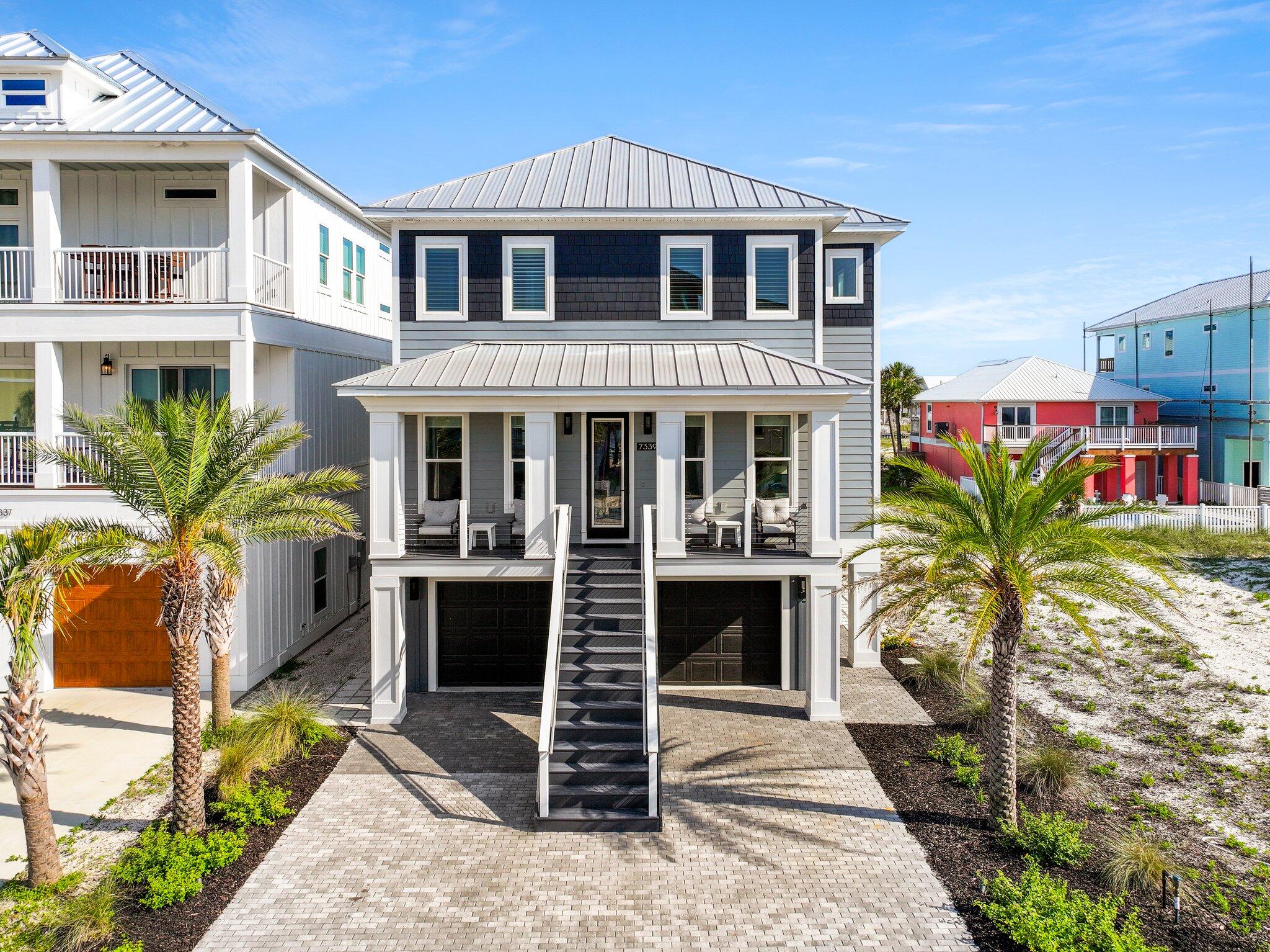 Are you ready to live your best life at the beach?? STUNNING 2020 custom built and meticulously maintained luxury home offers the perfect blend of latest building standards and comfort, making it an ideal sanctuary for worry-free relaxation and entertainment. Located in the Sound front community of Grand Navarre on the west end of Navarre Beach, this home provides views of Santa Rosa Sound with easy access to pristine white-sand beaches and the crystal-clear waters of the Gulf of Mexico. Built to current coastal standards with pilings, fiber cement siding, secondary water protection, a metal roof, impact-resistant windows and doors and foam insulation, this energy-efficient home is engineered for the Gulf Coast lifestyle. Geothermal heating and cooling offers durabity and efficiency with system protection from the environment. This residence boasts spacious and beautifully appointed living areas designed with both style and functionality in mind, all accessible with a finished elevator servicing the ground floor to the top floor. High ceilings, large windows and an open floor plan create a bright and airy atmosphere, perfect for entertaining guests or enjoying quiet family evenings. The state-of-the-art two island kitchen is a chef's delight, featuring Thermador smart appliances, gas stove, wine cooler, two ovens, warming drawer, quartz countertops, and custom cabinetry. The home includes three bedrooms, each designed as a private retreat with ample space, natural light, and elegant finishes. The master suite offers a spa-like experience with a walk-in closet, a lavish en-suite bathroom with dual vanities, elegant lighting and a large two-head shower. Step outside to your covered deck with firepit and tropical back yard, perfect for sunbathing, hosting barbecues, or simply relaxing with a good book while enjoying the gentle sea breeze. This home is equipped with modern amenities to enhance your lifestyle, including a smart home system, whole home surround sound, remote controlled window shades, LED lighting, keyless locks, security system and a three-car garage. The quality truly stands out.
Whether you are seeking a fabulous primary or secondary residence or an income producing investment, owners and guests will delight in an elevated beach house experience with this home. Home is being sold fully furnished and turn key with golf cart included!