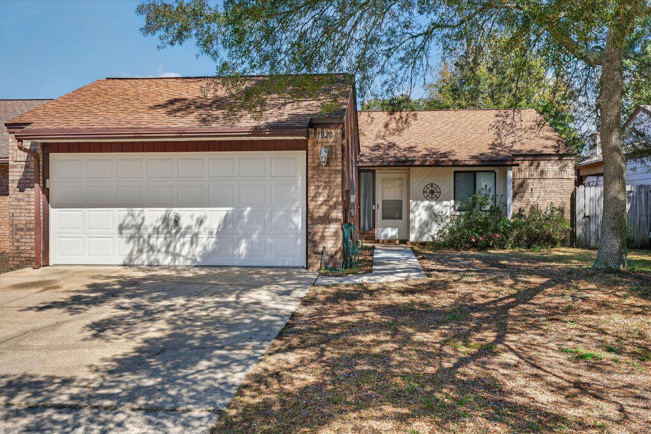 Welcome to this charming garden home in Niceville's desirable Cedar Ridge neighborhood with NO HOA, plus sidewalks and underground utilities. This inviting 2-bedroom, 2-bath residence with a 2-car garage blends comfort and character throughout.

Step inside to fresh paint, new laminate flooring in the foyer, kitchen, and baths, and plush new carpet in the living room and bedrooms. The spacious living area impresses with a cathedral ceiling and a cozy brick fireplace accented by beautiful woodwork. The galley-style kitchen includes a gas range, original wood cabinetry, and a bright breakfast nook highlighted by a distinctive Tiffany-style light fixture.

Enjoy a private, fully fenced backyard with two covered porches--perfect for relaxing, entertaining, or letting pets play. Conveniently located and move-in ready, this home is waiting for you. Schedule your private showing today!