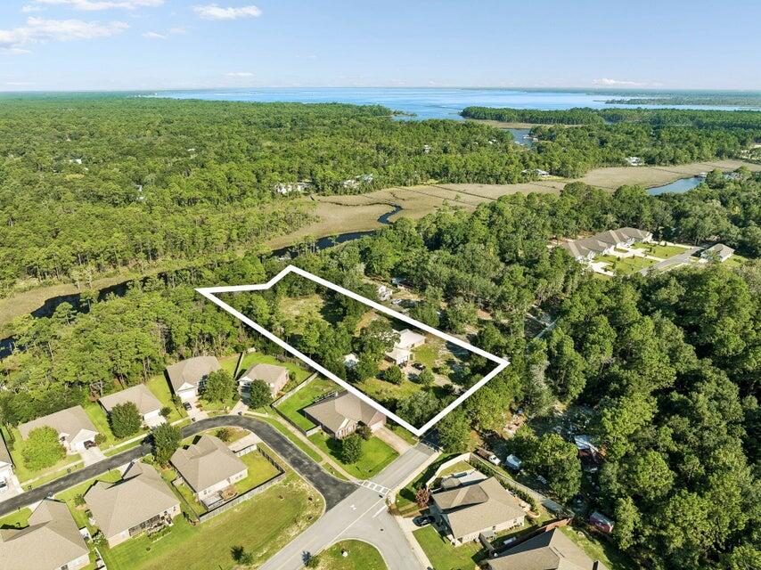 Rare 2.21-acre waterfront estate lot on Peach Creek with 175' of water frontage and a private dock with boat lift providing direct access to Choctawhatchee Bay. Tucked at the end of a quiet cul-de-sac and screened by mature pines and hardwoods, this property offers a level of privacy hard to find in South Walton. Nearly 2.5 unrestricted acres of deep-water creek frontage minutes from the bay is a rare offering this close to 30A - bring your vision and build your dream estate. A home and detached garage currently occupy the site. Just steps to nature, yet convenient to Santa Rosa Beach shopping, dining, and the beaches.