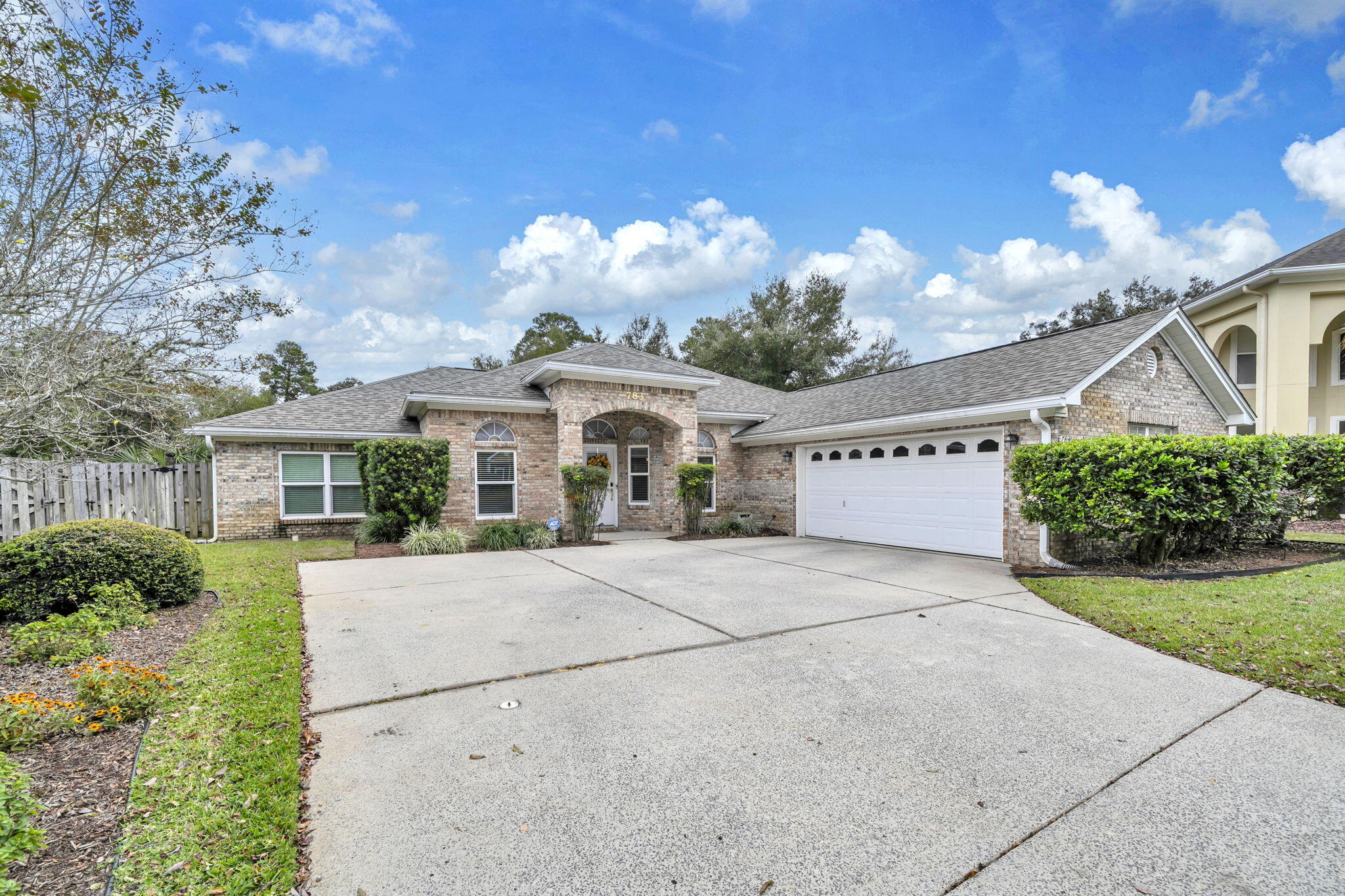 This well-maintained, single-owner brick contemporary residence is centrally located in Fort Walton Beach. Built in 2004, the home offers four large bedrooms with a desirable split-floor plan, including an oversized master suite and a spacious bathroom. Hardwood floors enhance the living and dining areas, while tile is featured in the kitchen and bathrooms. The kitchen provides a functional layout with ample cabinetry and pantry space, complemented by a breakfast nook ideal for family meals. The attached garage accommodates vehicles and additional storage needs. Entry from the garage leads directly through the laundry room to the kitchen, allowing convenient access regardless of weather conditions. The Florida Room was a favorite spot for this owner to relax and enjoy the back yard. Situated on an oversized lot, the property offers flexibility for future enhancements such as a pool and backs up to a subdivision retention area, ensuring additional privacy. This setting provides a unique combination of space and seclusion within the neighborhood. New roof was installed in 2023. 
Bridgeport Colony is among the most prestigious but friendliest  subdivisions in the area, with low HOA fees that contribute to the upkeep of the well-maintained landscape, gated entry, and community pool.