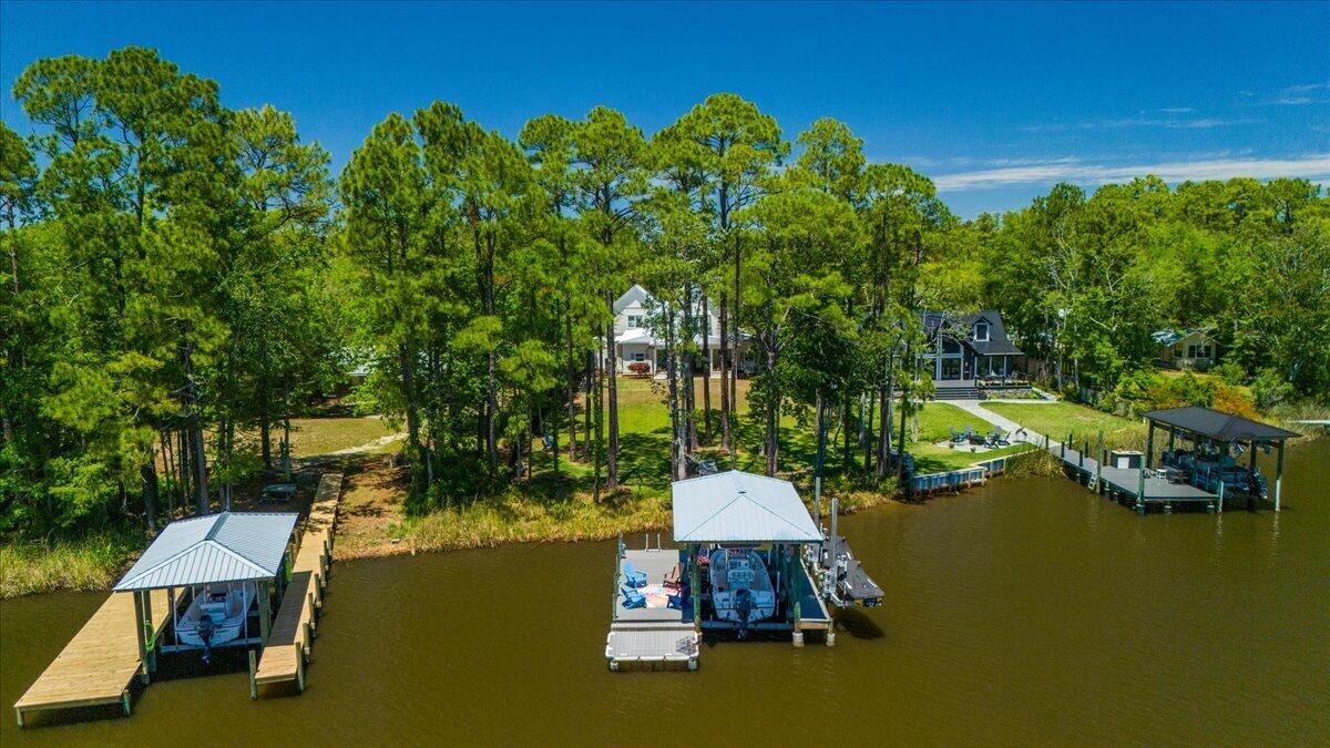 BAYOU FRONT WITH BOAT DOCK! This coastal custom home is set on a protected bayou with serene water views. Enjoy your private dock which has $36k of upgrades that include a lift for a boat and 2 jet skis. The apartment above the garage offers versatility for an Airbnb or office. Enjoy Southern charm with brick pavers throughout, high ceilings, deep covered porches, including a 24x16 rear porch, and a fenced backyard with a small citrus grove. As a bonus, a 26kw whole-home generator supports both structures and the dock with 2 owned propane tanks. The main home offers 3bed/3.5 baths and a downstairs primary suite with a modern closet, soaking tub, and separate shower. The kitchen showcases an oversized island, gas range and extra storage in the kitchen galley. No HOA & room for a pool! Don't miss out A beautifully pavered driveway leads to the 2-car garage with a apartment above--complete with private bedroom, living area, bathroom, and kitchenette, ideal for rental income, guest suite, or office.

Located within easy reach of 30A, Blue Mountain Beach, and Grayton Beach, easy boating to North Beach and The Bay restaurants or head to Crab Island in Destin--perfect as a primary residence, second home, or investment opportunity.