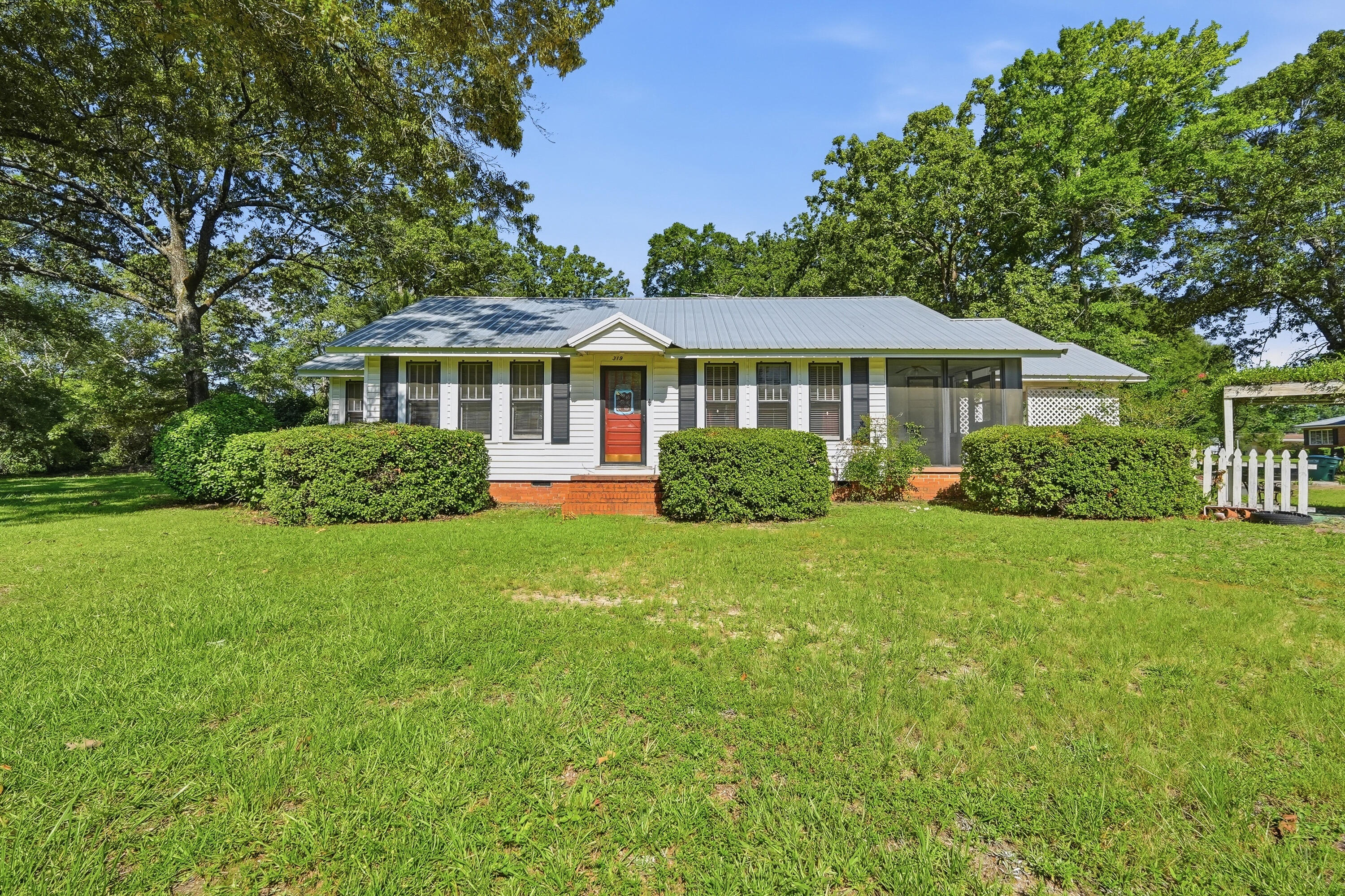 Positioned directly on highly traveled Highway 331 N, this unique property offers exceptional visibility and endless possibilities. Zoned Mixed Use and situated on four city lots totaling approximately 0.9 acres, it's an excellent opportunity for a residence, business, investment, or a combination of both. The home features 2 bedrooms and 1 bathroom with beautiful original hardwood floors throughout, including beneath the bedroom carpeting. The spacious primary bedroom includes an impressive 7' x 10' walk-in closet, while the living room offers a cozy gas fireplace that adds warmth and character. An enclosed front sunroom provides the perfect place to relax with your morning coffee or create a bright home office. Additional features include an attached covered carport, two storage sheds, and a roof that was replaced in 2022 for added peace of mind.