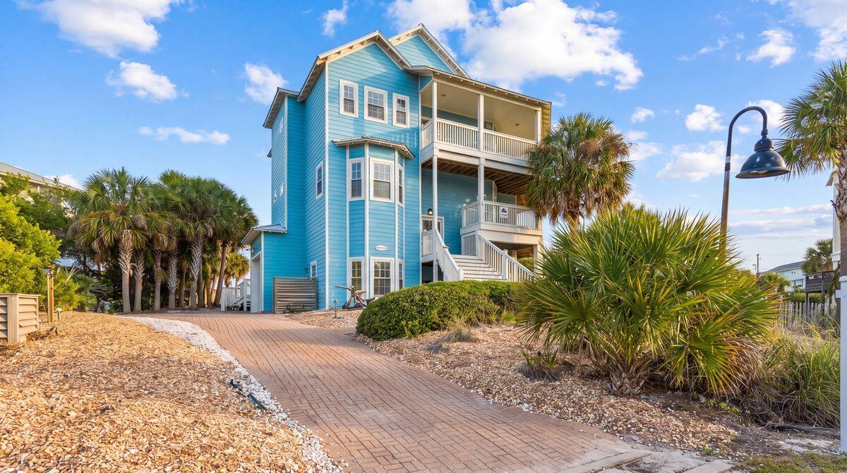 Positioned just across from deeded beach access, this furnished first-tier coastal retreat offers the space and sweeping Gulf views of a beachfront escape. With approximately 3,809 square feet of thoughtfully designed living space and an additional 3,700 square feet of outdoor living, the home features six bedrooms, five full baths, two half baths, multiple covered decks and a private in-ground pool--an impressive setting for large gatherings, extended stays or a high-capacity vacation rental.  The home unfolds across three levels, balancing generous gathering spaces with private bedroom accommodations. The ground level includes two bedrooms, a full bath and half bath, garage storage with a ping-pong table, an outdoor shower and direct access to the private pool. Parking for up to four vehicles adds convenience for larger groups.  The second level offers an additional living area with a queen sleeper sofa, two king bedrooms with private en suite baths and deck access, a queen bedroom, a full hall bath and a dedicated laundry room. This flexible layout separates sleeping and entertaining spaces while giving guests plenty of room to spread out.  The third level serves as the heart of the home, where the open-concept kitchen, dining and living areas take full advantage of the elevated Gulf views. A spacious dining table seats eight, while the expansive wraparound deck extends the gathering space outdoors with Polywood dining furniture and views that capture both sunrise and sunset. The primary suite is also located on this level and features a king bed, private en suite bath and direct deck access.  Multiple covered decks provide abundant space for dining, relaxing and enjoying the coastal setting, while the private in-ground pool offers a refreshing retreat after a day at the beach. Deeded beach access is located directly across the street, placing the white-sand shoreline approximately 100 steps from the front door.  For buyers seeking income potential, the property offers a strong rental history with impressive rental numbers. Its six-bedroom configuration, expansive indoor and outdoor living areas, private pool and exceptional proximity to the beach make it especially appealing to larger vacation groups while retaining the comfort and flexibility desired in a second home.  The gated Seagrass community further enhances the coastal lifestyle with a community swimming pool, clubhouse, landscaped common areas, underground utilities and deeded beach access. The home is also convenient to the Loggerhead Run Bike Path, Salinas Park, St. Joseph Peninsula State Park, boating, fishing, kayaking, local dining and miles of white-sand beaches along Cape San Blas.  Furnished and designed for gathering, this spacious retreat combines sweeping Gulf views, outstanding beach proximity, a private pool and proven rental performance in one compelling coastal property.