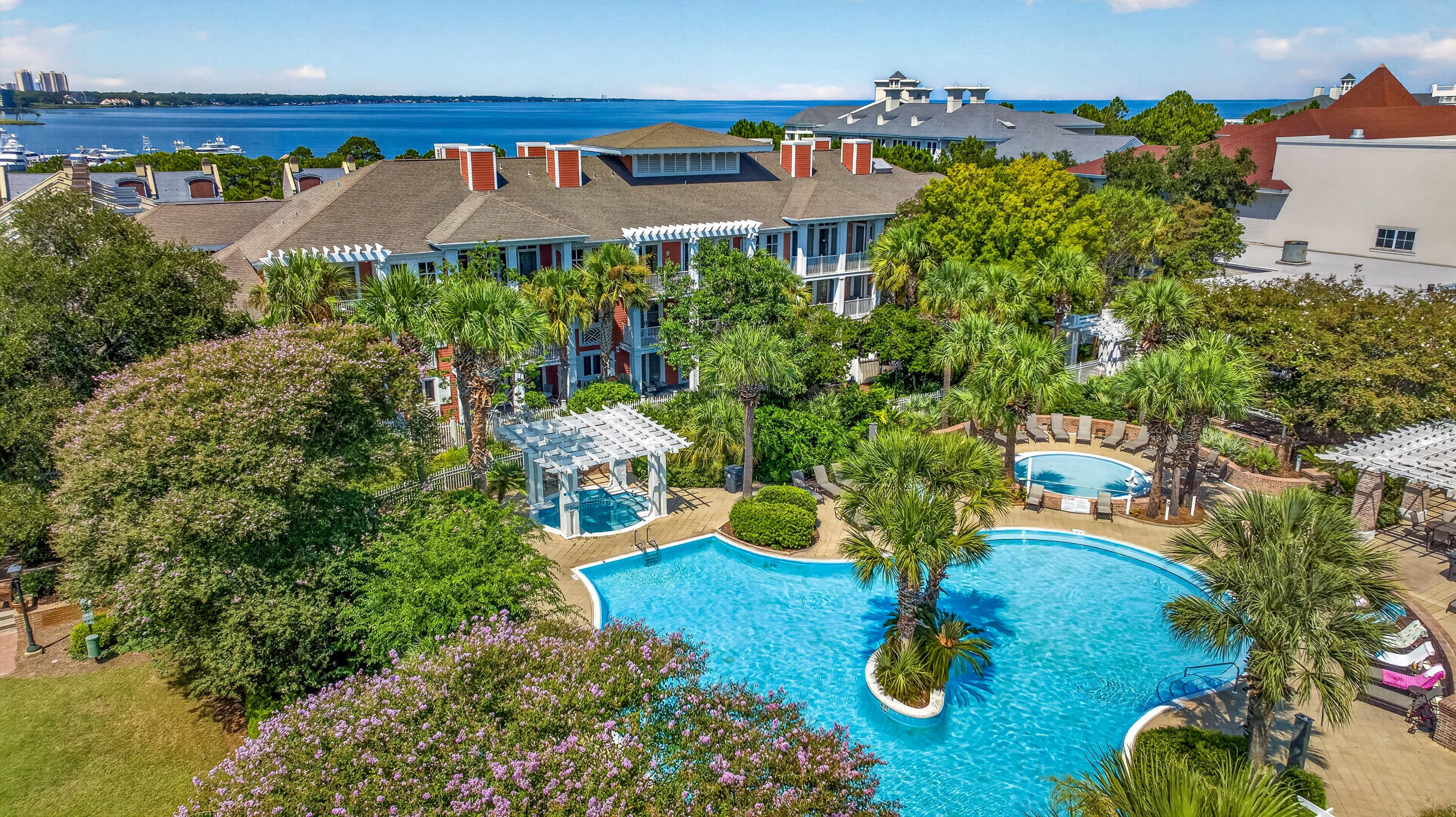 Rare 5th-floor end unit in Market Street Inn offering the best of both worlds with dual balconies and two distinct views. This desirable floor plan enjoys an east-facing balcony overlooking the lush amenity terrace and resort-style pool, while the west-facing balcony provides views of the pedestrian pathway leading directly to the vibrant Village of Baytowne Wharf--an ideal spot for people watching during festivals and special events. The east balcony is conveniently accessed from the primary suite, while the west balcony extends from the living room, creating inviting outdoor spaces.

As a top-floor end unit, this residence offers added privacy and a peaceful retreat, complemented by new LVP flooring throughout. The open living area is filled with natural light, and the kitchen features stainless steel appliances. The oversized guest bedroom offers two full-size beds, providing comfortable accommodations for family and guests.

Market Street Inn owners enjoy exclusive access to the beautifully landscaped amenities terrace, complete with a resort-style pool, hot tub, fitness center, expansive lawn, and grilling area. Owners also have access to the Founders Club, featuring a game room with pool table and bar, plus a balcony overlooking the events plaza.

Just outside your door, the Village of Baytowne Wharf offers waterfront dining, boutique shopping, and a lively calendar of festivals, concerts, and family-friendly events. As an introduction to the Sandestin lifestyle, we invite our new owners to explore amenities that make Sandestin special. The listing brokerage and seller(s) are presenting the buyer(s) of this property with (2) 90-minute rounds of Tennis court time, a golf foursome at one of our three championship courses, and a round of golf for up to four (4) players at the unrivaled Burnt Pine Golf Club.