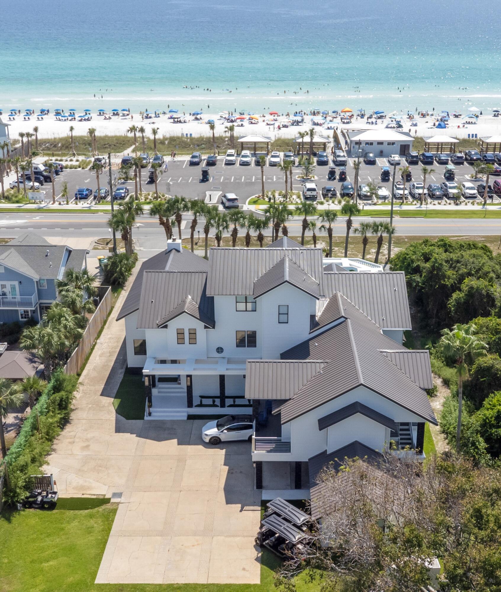 OPEN HOUSE SATURDAY 12-3PM Located in Crystal Beach one-of-a-kind luxury beach estate, NO HOA, where Gulf views, elegance, entertainment, resort-style amenities and cutting-edge smart-home technology come together under one roof.  6700+ sq ft featuring 9 BR 8BA+3 half baths and nearly every room has Gulf views. The home is located Directly Across from Tarpon Beach Access with the beach practically at your doorstep. The Salt Water Heated Pool is 37x20 ft, sauna, jacuzzi and  covered pool lounge area with a grill and outdoor bar. The  residence is suited for large families, extended stays, multi-generational vacations, and memorable group getaways. The master bathroom includes a separate steam room, creating a true spa-like retreat. The 3rd Level has DJ Booth & Disco Lights, a Mechanical Bull Arena, smoothie machine, mini bar and a balcony overlooking the Gulf. Spray Tanning booth is in the garage next to the work out equipment. The home offers a sophisticated smart-home system with a master control tablet that allows you to manage the pool, sprinklers, air conditioning, stoves, air fryers, the grill, washers & dryers. A dedicated panic room provides an additional layer of security and peace of mind. Luxury finishes and upgrades throughout, designer flooring, floor-to-ceiling tile bathrooms, quartz countertops, gas range with a custom drop-in hood vent. The home is equipped with a full-house generator and 2 golf carts included in the price. No Flood Zone. See More Section Major exterior improvements include a new metal roof, new railings and columns, new siding, and fresh exterior paint. The home is equipped with multiple AC units and a full-house generator, delivering exceptional comfort, convenience, and year-round reliability. One of the home's living spaces incorporates a chapel, offering a serene and intimate setting for worship, reflection, or special gatherings. This unique feature can also be easily adapted back into a traditional living or entertainment space to suit the new owner's vision.
Parking is never a concern with 8 dedicated parking spaces, plus two golf carts included with the home. Enjoy everything the beachside lifestyle has to offer. The backyard has shaded areas, privacy fence, and enough space for adding a carriage house. 
Flood Zone X. This property is a must see! Too many details to list. Okaloosa County website has the effective year built 2010 based on the extensive renovations. (Actual Year Built 1992)