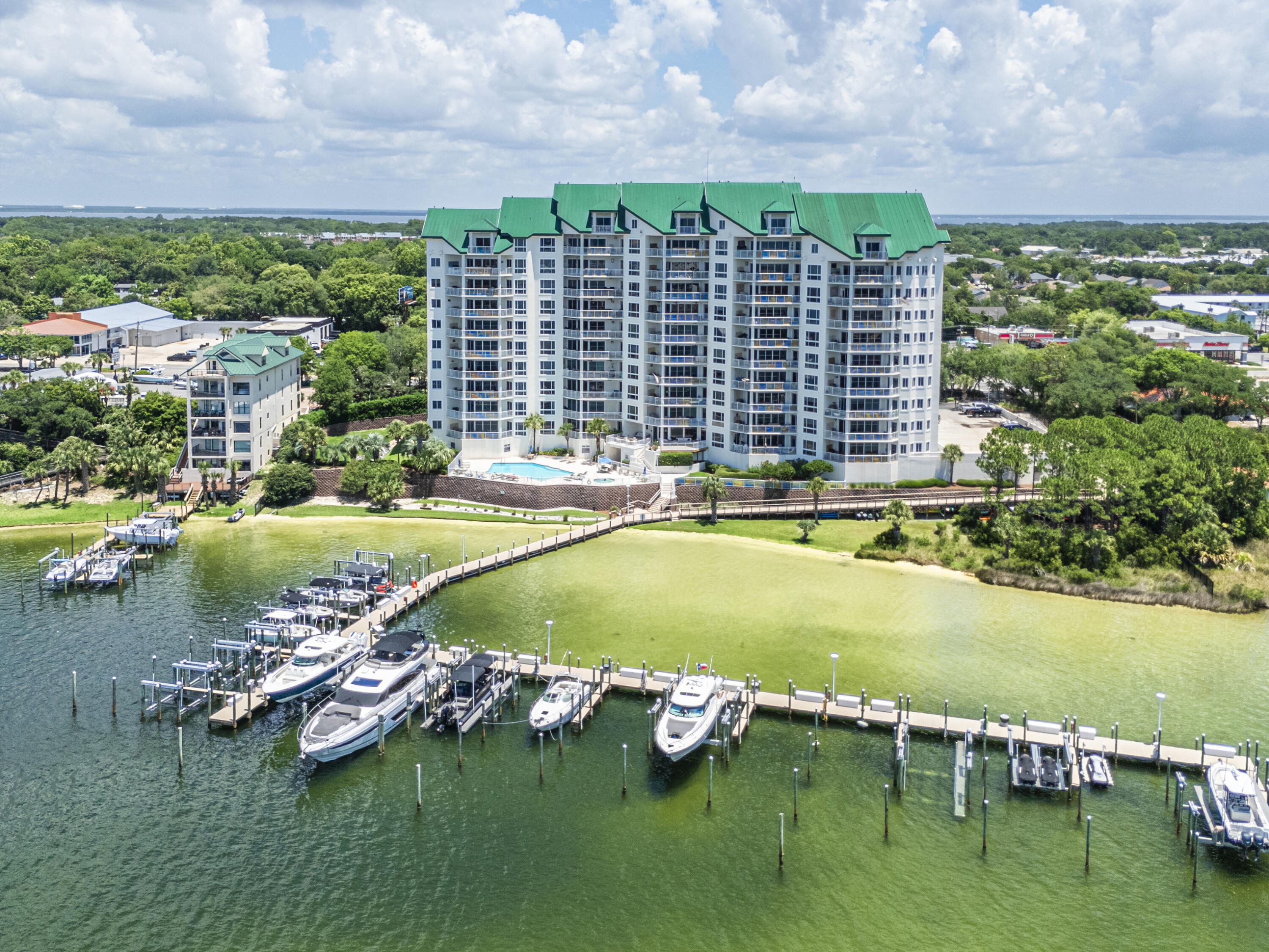 Grand Harbor Unit 1040 is a breathtaking penthouse offering 4,315 square feet of luxury waterfront living with panoramic views of both the harbor and Gulf of Mexico. From the dramatic lit spiraling staircase to the full Lutron automation system, designer motorized draperies, and custom ceiling designs throughout, every detail reflects an extraordinary level of finish. The chef's kitchen features Viking appliances, gas cooktop, double wall ovens, custom ornate cabinetry, granite countertops, wine refrigerator, ice maker, and a large island with sink. The living room offers a fireplace and built-in bookcases, while the spacious balcony includes a built-in gas grill -- all with stunning water views. Two master suites each feature trayed ceilings, private balcony access, and spa-quality baths with separate walk-in showers, soaking tubs, double vanities, and marble throughout. Additional highlights include a purpose-built media room with cinema sound, a home office with built-ins, and a full laundry room. A deeded boat slip with motorized lift is included. Community amenities include a gated entrance, pool, fishing dock, fitness center, covered parking, owners' gathering room, and a guest apartment available to owners' guests. This is Destin waterfront living at its finest.
