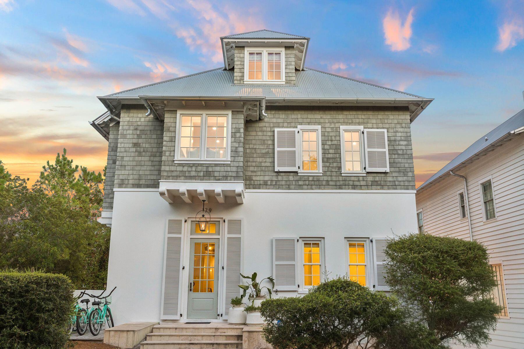 Set within the coastal community of Rosemary Beach, this newly renovated custom Benecki residence blends architectural scale and modern coastal living just moments from the Gulf. Spanning approximately 6,000 square feet, the six-bedroom, eight-bathroom home was designed by Atlanta designer Melanie Turner with an emphasis on detail, this property features limestone floors, hand-crafted beams, Venetian plaster walls, custom millwork, and oil-rubbed bronze fixtures establishing a timeless interior palette rooted in time rather than trend. The main living area centers around a feature fireplace and a chef's kitchen anchored by an expansive social bar overlooking the living room. A 12-foot glass sliding door extends the interiors into a private courtyard with a resort-style pool, covered lounge areas, and landscaped outdoor living space that neighbors the separate guest quarters above the detached two-car garage complete the residence, offering a rare balance of architecture and luxurious retreat. The second floor introduces a quieter rhythm with an expansive primary suite, oversized walk-in closet, and a carefully designed bath beneath a statement chandelier. Additional guest suites maintain privacy through thoughtful circulation and scale, while the third floor adds flexibility with a large bunk room, surround-sound movie room, and additional guest accommodations.
