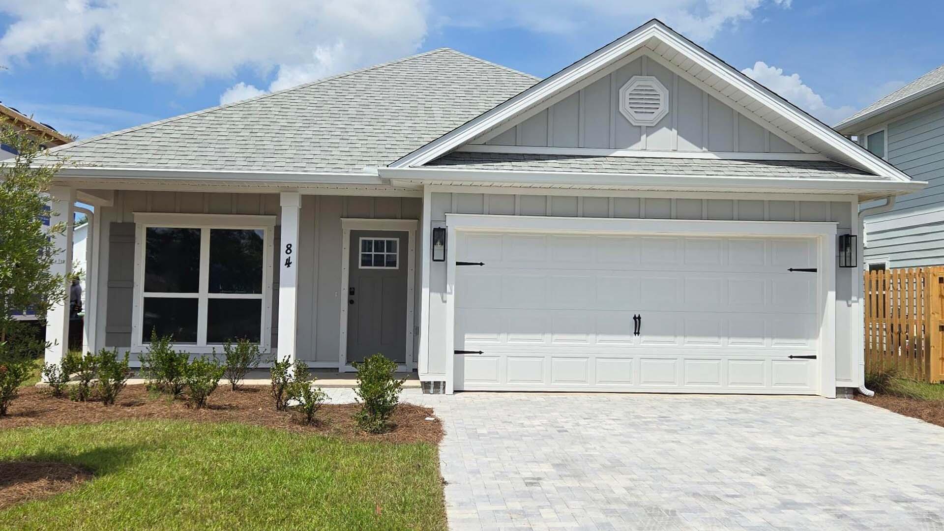 Welcome to 84 Dylan Drive at Crest Bay Cottages in Miramar Beach, Florida. This home is ready for move in and backs up to a small pond. The Oakley is designed for both style and functionality and welcomes you with a flex room or private study just off the front entry. The foyer opens into a spacious, open concept living area where a vaulted ceiling in the family room enhances natural light and creates an airy, upscale feel perfect for everyday living and entertaining. 

The kitchen serves as the heart of the home, featuring abundant upper and lower cabinetry, a center island, and sleek matte black finishes that add a modern, designer touch. Equipped with a gas cooktop, the kitchen is well suited for home chefs who appreciate both performance and style, while offering ample counter space for meal prep and gatherings. 

The primary suite provides a relaxing retreat complete with an ensuite bathroom. The primary bath includes a generous closet, dual sink vanity, shower and a separate soaking tub for added comfort. Two additional bedrooms are situated in a separate hallway and share a full bathroom with a tub and shower combination.