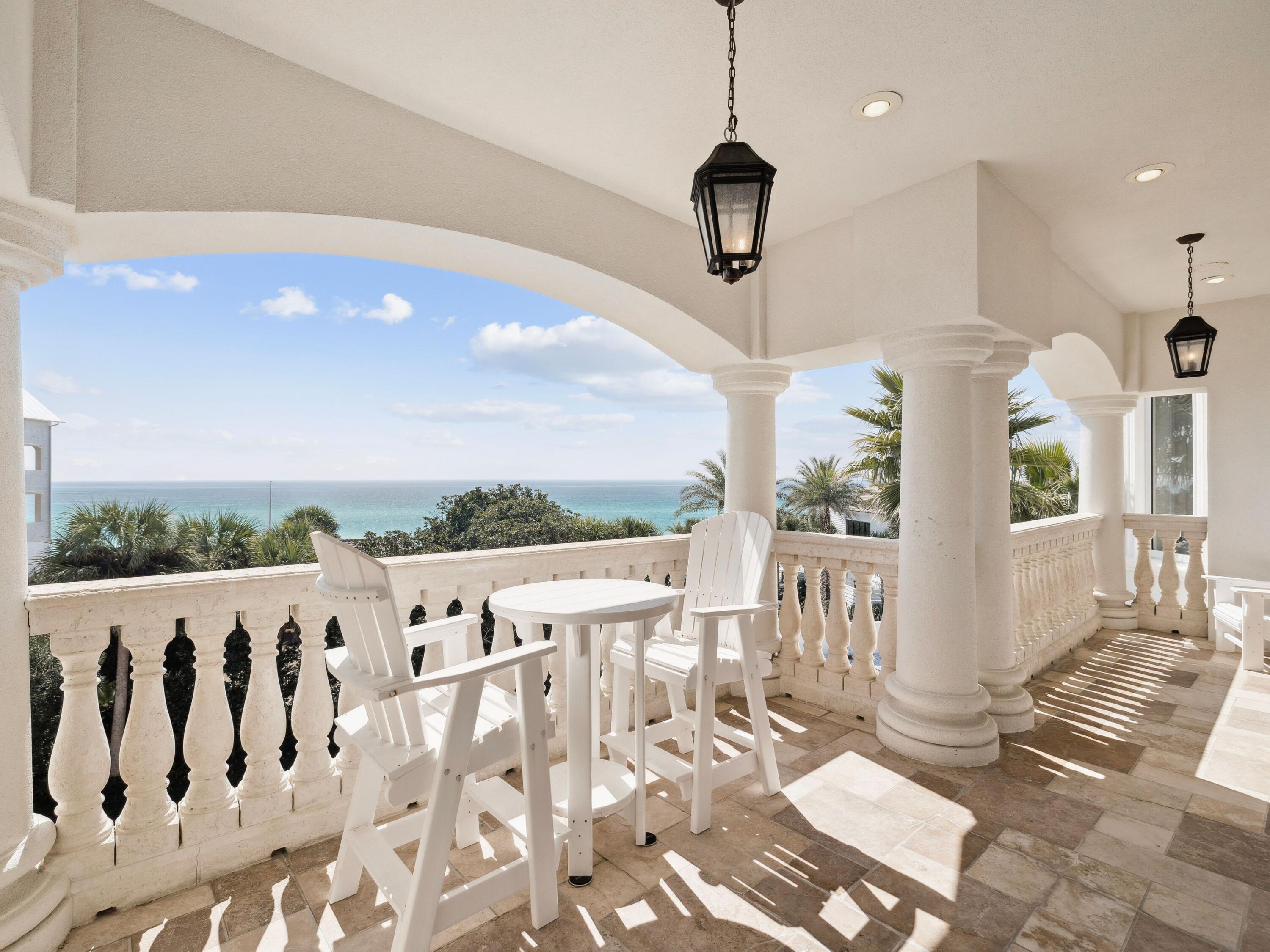 Positioned within the gated enclave of Pelican Circle along Scenic Highway 30A, this exceptional coastal residence offers a rare opportunity just moments from the Gulf's white sand shoreline and the rare coastal dune waters of Camp Creek Lake. Tucked behind private gates and set within one of the area's most discreet beachside corridors, the property pairs architectural presence with a location defined by both exclusivity and natural beauty. Spanning more than 5,500 square feet, the home is thoughtfully designed to balance expansive gathering spaces with private retreats, all oriented to capture sweeping views and seamless indoor-outdoor living. An elevator provides effortless access to each level, ensuring both convenience and long-term livability without compromise. In 2025, the residence underwent a comprehensive interior refresh, including full interior repainting, all new designer furnishings, updated lighting throughout, and new pool equipment, enhancing both its aesthetic appeal and operational performance.

The arrival experience is both striking and intentional. A circular drive and custom pergola frame the approach, leading to a dramatic iron entry. Inside, soaring ceilings and generous proportions create an immediate sense of scale. The first floor is designed with both entertainment and functionality in mind, featuring a spacious bunk room ideal for hosting multiple guests and a dedicated movie theater that transforms evenings into a private cinematic experience.

At the center of the outdoor living experience, a secluded courtyard is enclosed by a tall stone wall, offering privacy rarely found this close to the beach. A heated pool and spa, complemented by a built-in grotto and cascading waterfall, create a resort-style setting equally suited for quiet mornings or elevated entertaining.

The second level introduces the main living space, anchored by a chef's kitchen and dining area designed for gathering. Multiple balconies extend the living areas outward, capturing Gulf views from the front and serene pool views from the rear. Two additional king suites share a well-appointed bath with a walk-in shower and dressing area, providing comfort and privacy for family or guests.

On the top floor, a glass-enclosed fitness room, secondary laundry, and powder bath add convenience and flexibility. A guest primary suite enjoys its own private balcony and spa-inspired bath, while the main primary suite commands the home's most compelling Gulf views. Complete with an expansive terrace, custom dressing room, heated bathroom floors, soaking tub, and walk-in shower, it serves as a true private sanctuary above the coastline.

Primely positioned within gated Pelican Circle, just steps from the beach and minutes from the natural beauty of Camp Creek Lake, this recently refreshed residence offers a compelling blend of lifestyle, privacy, and long-term value. With exceptional scale, resort-caliber amenities, elevator access, and meaningful upgrades completed in 2025, it represents a rare offering along 30A for those seeking refined coastal living with enduring investment potential.
