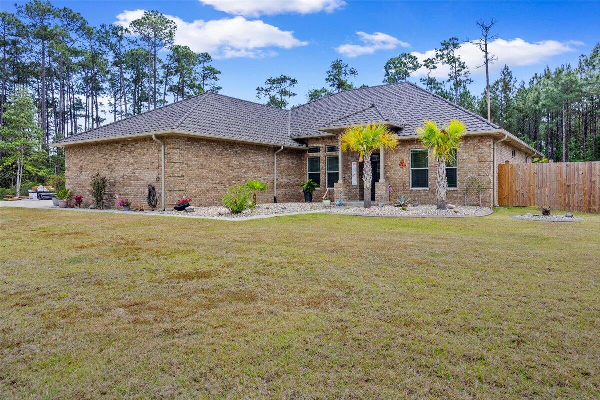 This gorgeous custom-built estate offers a rare blend of refined luxury and tranquil sanctuary living on a pristine .92 acre setting. Step into soaring 12' ceilings, exquisite architectural details, and an open living space centered around a sleek gas fireplace and gourmet kitchen designed for both style and performance. The primary suite evokes a boutique resort feeling with serene finishes and a spa-like ambiance. Outside, a beautifully designed covered patio overlooks a shimmering inground fiberglass saltwater pool, great landscaping, and a raised garden There are 2 additional buildings for creative pursuits.  A stunning guest house elevates this property even more for  multi generational living.  NEW METAL ROOF MAR 2026 50 YR WRNTY