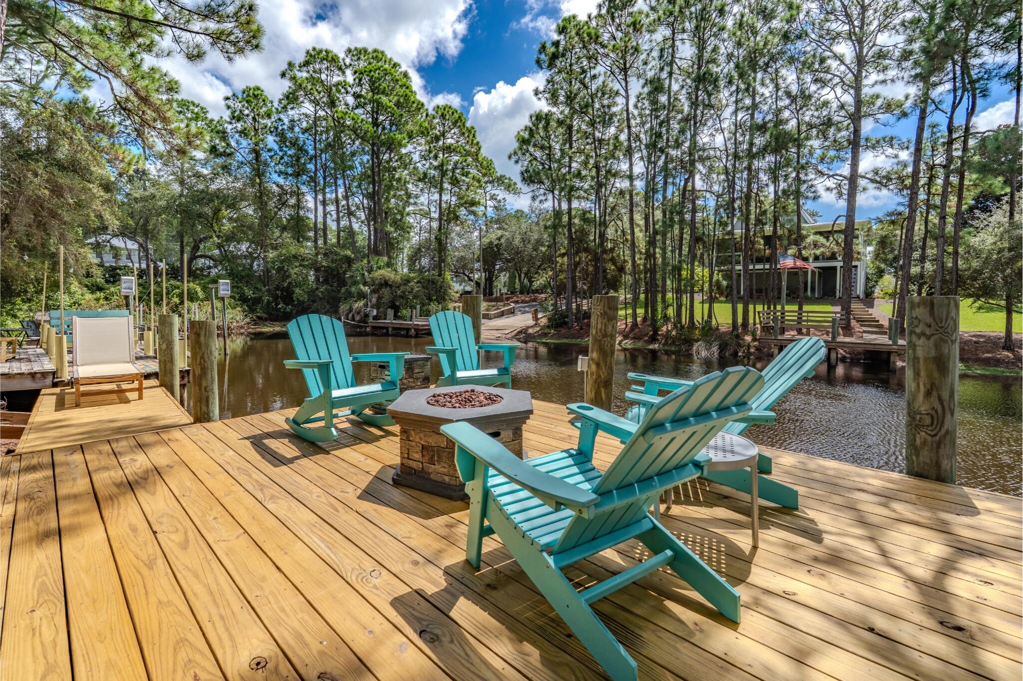 EASTERN LAKE ACCESS WITH UPDATES UPDATES UPDATES! Unit 5 at Lakewood at Seagrove has undergone beautiful updates making it the ideal location for your extended vacation. Or maybe you're looking to put down some roots at this waterfront townhome. No matter if you're the savvy investor or the settling in kind, this townhome has so much to offer. From floor to ceiling, you will notice the finest of accents and designs like the shiplap walls and ceilings, the oak wood ceiling beams, the natural light, the engineered hardwood flooring, and the well-appointed use of space.
The kitchen features oversized double islands, stainless steel appliances, quartz countertops, drink bar with beverage fridge and ice maker and a shiplap ceiling. The 1st floor bedroom has access to the large deck, ensuite bathroom with large vanity and a spacious walk-in closet with built in shelving. The ceiling beams in the living room really catch your attention and welcome you to the open space, and let's not forget the convenience of the downstairs half bath.  Manufactured hardwood floors can be found throughout the home both downstairs and upstairs. On the back covered and screened in porch you can enjoy those late spring and early fall evenings, or maybe you would prefer a drink on your dock.  Enjoy your private dock to take your boat, paddleboard or kayak out on Eastern Lake, right from your back yard!
Upstairs you have another suite with clerestory windows offering loads of natural light while also keeping your privacy, not to mention the water views. The vaulted ceilings really enhance the feeling that you are not in a townhome. Headed down the hallways of the suite you have a beautiful barn door for privacy from the covered balcony access and the full bathroom with walk-in, floor to ceiling tiled shower (there's also a bench seat!). The "Kid's Room" has access both to the suite and the hallway at the stairs and features not 2 but 3 bunks on the wall, an alcove for the bed, and a private half bath. No detail has been missed in this gorgeous lake house. 

Being in Seagrove, you are surrounded by nature. This isn't your typical "Beach House" this is a "Lake House" with mature trees, quiet streets, and cozy small town vibes. Only 0.5 miles away is Old Florida Fish House, a culinary landmark in Seagrove, you've also got Beach Happy Cafe, Beachy Bean Coffee and more. Besides the almost direct access to Eastern Lake, are the two public beach access points, one at Walton Dunes Beach and the other at Sugar Dunes Beach. Both are 0.5 miles away. Watersound and the Big Chill are both less than 2 miles front your front door. And Watercolor is less than a 10 minute drive. Close to everything, yet tucked away in the trees. Don't miss your chance to see this one in person.