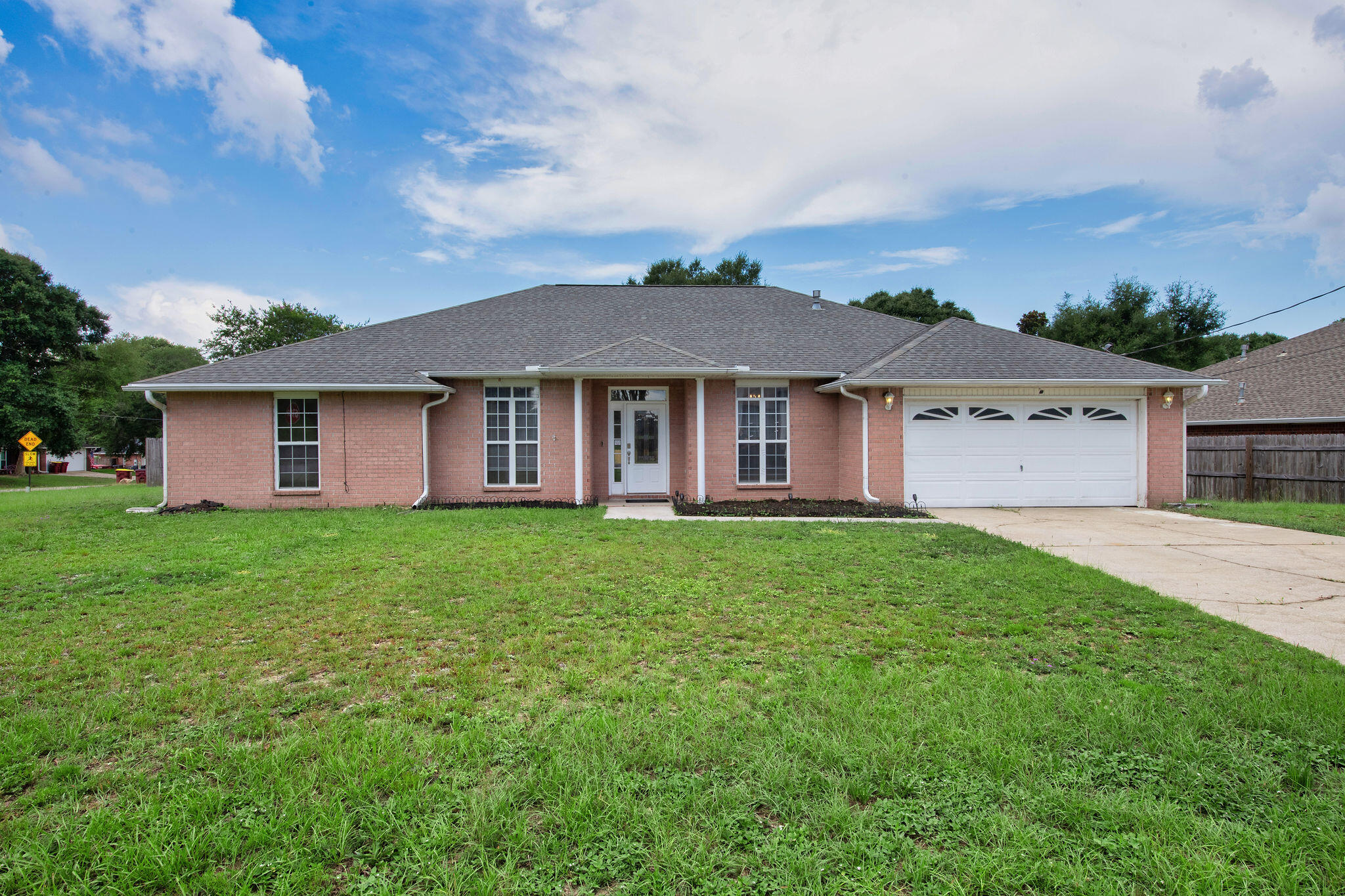 Spacious, updated, and conveniently located, this 4-bedroom, 2-bath Crestview home offers over 2,300 square feet, a 2021 roof, no HOA, and a large fully fenced backyard. Inside, you'll find multiple areas to spread out, including a generous family room with cathedral ceilings, formal dining space, breakfast bar, and a flexible bonus-style room currently used as a gaming room. The renovated primary bath is a true highlight, featuring a double vanity, walk-in closet, and a large tile shower that gives the suite a more elevated feel.

Step outside to enjoy the screened porch and oversized backyard with plenty of room for a pool, shed, garden, playset, pets, or entertaining. Located just 1 minute from I-10, 4 minutes to Hwy 85, 8 minutes to Publix, 15 minutes to Duke Field and 7th Special Forces Group, 25 minutes to Eglin AFB, and about 41 minutes to Hurlburt Field, this home offers space, convenience, and flexibility without the restrictions of an HOA.