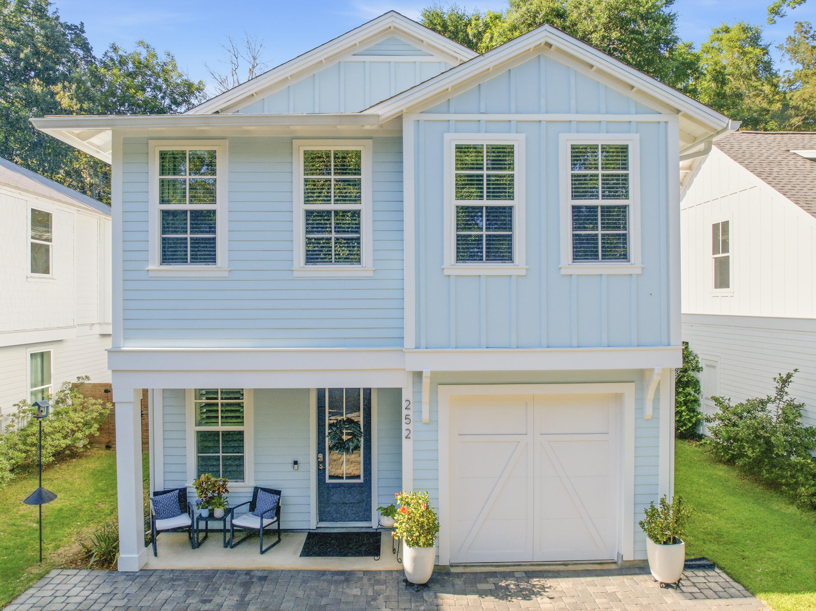 Nestled in the magical bayou-front Sacred Oaks community with neighborhood dock access and direct connection to the bay, this beautifully upgraded home by luxury builder CoaStyle Homes perfectly captures the essence of coastal living. Located just minutes from the area's sugar-white beaches, you can hop on your golf cart and head to Grand Boulevard for dinner, movies, ice cream, coffee, or shopping. Surrounded by majestic oak trees and known for its charming brick-paved streets, picturesque wooden bridge walkover, friendly neighbors, and peaceful waterfront setting, this one-of-a-kind community offers a relaxing lifestyle. Conveniently located near Ascension Sacred Heart Hospital, this home combines beauty with everyday convenience.

Thoughtfully designed with high-end finishes throughout, this home features luxury vinyl plank flooring, crown molding, plantation shutters, custom closets, impact windows, and a striking electric fireplace with a built-in bench that creates a warm and inviting focal point in the living area.

 The open floor plan is ideal for entertaining and every day living. The first floor includes a flexible bedroom that can also serve as a private office, along with a full bathroom with an enclosed glass shower.  The spacious living area flows seamlessly into the chef's kitchen, complete with a large island with quartz countertops, custom cabinetry, stainless steel appliances, a gas stove, and elegant gold hardware. The pantry and under stairs storage provide added functionality.

Upstairs, the spacious primary suite offers a spa-like walk-in shower and an incredible custom-designed closet. Two additional guest bedrooms upstairs provide comfortable accommodations for family and visitors, while the upstairs laundry room with built-in cabinetry adds every day convenience.

A rare golf cart garage offers endless versatility and can easily serve as a workout room, hobby space, or additional storage. The attic also includes added storage access.

Outside, enjoy a newly redesigned deck with gates, upgraded horizontal fencing, gutters, and a fenced trash enclosure that enhances the home's polished exterior. 

Whether you are paddleboarding along the bayou, fishing from the community dock, or gathering with neighbors to watch the sunset, this home offers a peaceful coastal setting and is ready for you to make lasting memories. Schedule a showing today!