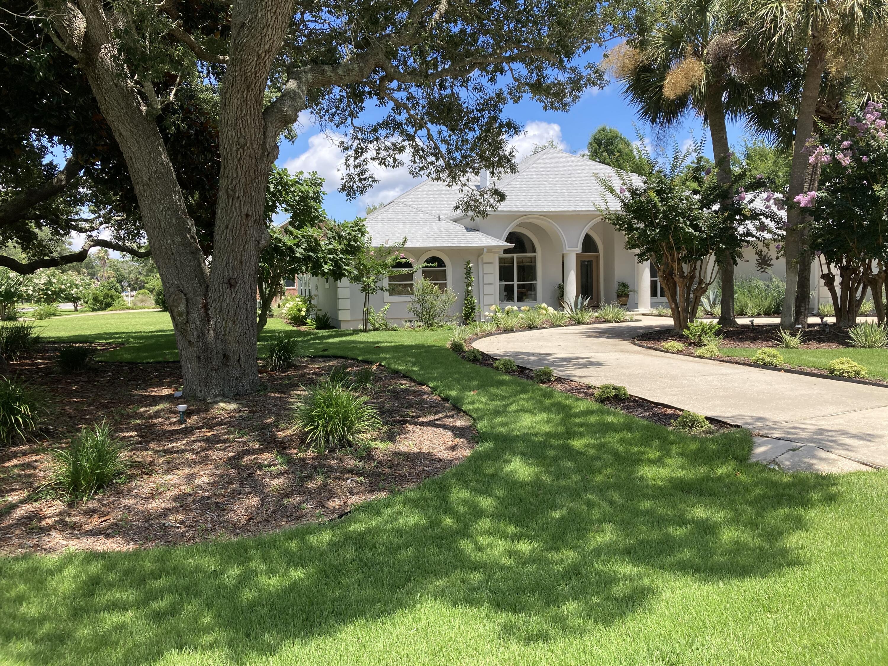 From the moment you arrive, this meticulously renovated home stands out with excellent curb appeal, professional landscaping, and a circular driveway. Step through the double-door entry into a bright, spacious floorplan featuring high ceilings, curved windows, and distinct architectural details. The layout includes a formal dining room and a versatile flex space with a two-sided fireplace that opens to the large, sunny great room. A wall of doors that open a large covered and screened patio that runs the full length of the great room and connects this space to the kitchen, which is equipped with stone countertops, custom cabinetry, a tile backsplash, and premium stainless steel appliances. Easy-maintenance tile flooring runs throughout the entire home.

The oversized primary suite features a private sitting room, dual walk-in closets, and an ensuite bath with a garden tub, separate shower, and water closet. Two additional spacious guest bedrooms share a well-appointed, updated bathroom.

Outside, the property sits on an oversized corner lot in an excellent school district and includes a side-entry oversized 2-car garage with an extra parking pad. Ownership includes a full membership to Holley by the Sea's 45-acre recreational center. Enjoy access to 8 clay tennis courts, 3 swimming pools, a full gym, basketball courts, a sauna/steam room, and a community house on the Santa Rosa Sound with a playground and waterfront dock. Schedule your tour today!
