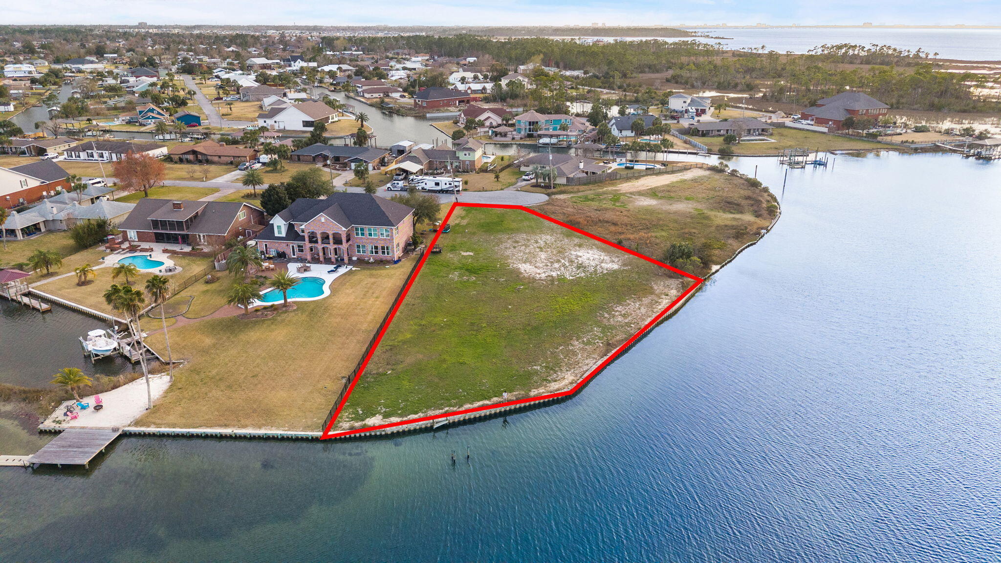 Incredible WATERFRONT OPPORTUNITY offering .76 ACRES of pristine, pure Bay views and approximately 232 feet of water frontage. This is the perfect homesite to build the forever dream waterfront home in Florida. 

With NO HOA making it highly desirable, this homesite is in one of Lynn Haven's most charming and sought-after waterfront neighborhoods in the Northshore area. Tucked away at the end of a cul-de-sac, this bayfront homesite provides beautiful open water views, a seawall already in place and is cleared, ready to build. A dock may be constructed to enjoy all that the waterfront lifestyle in Florida can offer. At just 10 nautical miles to the open Gulf of America, you'll be in the open Gulf waters in minutes, an easy trip to Shell Island on the weekends with the locals and be home for dinner to put fresh Snapper and Grouper on the table! This is the kind of property where you can truly enjoy the coastal lifestyle and capture a waterfront homesite that will stay in the family for years to come. Launch the boat from your future dock, spend the day fishing or cruising, paddleboard along the shoreline, or relax in your backyard watching the sunset over the Bay. 

Despite the peaceful setting, you're just minutes from the restaurants, shops, marina, and waterfront events in Lynn Haven, Florida, and a short drive to Downtown Panama City and the white sandy beaches. The homesite is large enough to accommodate an estate-sized home with a pool, carriage house, pole barn and so much more. Make this residence what you've always dreamed with no restrictions from an HOA! 

Large bayfront properties like this rarely come available. Build your dream waterfront home and enjoy boating, sunsets, and the relaxed coastal lifestyle right in your backyard.