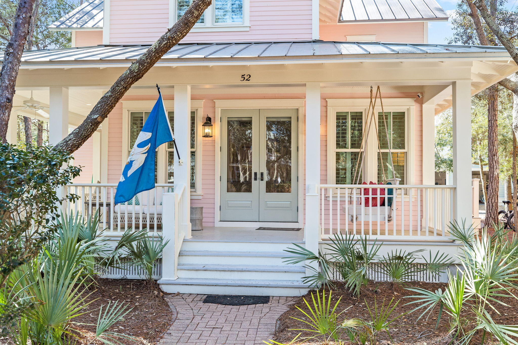 Located in Phase 1 Watercolor, 4 Bedroom, 4 1/2 bath property with a gorgeous wrap around porch overlooking Crimson Park in Watercolor! This home has just been renovated and newly furnished and is gorgeous with a 6-seater golf cart that conveys! The home offers plantation shutters throughout and has lots of natural light making it warm and bright and has all of the beach feels. The dining area is adorned with shiplap walls and crown molding and is an inviting area to enjoy dinner with family and friends. The kitchen offers marble counter tops and a large breakfast bar, beautiful white cabinetry, stainless steel gas range and microwave oven, deep single basin sink and cabinet fronted dishwasher and refrigerator, beachy blue subway tile backsplash and a window cut out into the large living area that has a little office nook, a stately white brick fireplace, white shiplap walls and ceiling and double doors that open to the wrap around porch! The first floor also has the highly sought after master bedroom which offers a spacious seating area, white shiplap and beamed ceiling, walk in closet and an ensuite master bath also with shiplap walls and crown molding, gorgeous tile flooring with a soaking tub with a beautiful chandelier above, stand alone shower with tile accent, dual vanities and water closet. The master bedroom also has double doors opening to the wrap around porch. A laundry area and half bath complete the first floor. The second floor offers a lovely sitting area with shiplap walls and crown molding with a wet bar accented with tile backsplash and 3 additional guest bedrooms, each with their own ensuite. With the exception of one bedroom upstairs the home offers hardwood floors throughout. The home has an exterior storage area, carport, paver driveway, outdoor shower and a large wrap around porch appointed with new exterior furniture to include a porch swing and several sitting areas. This home is in the front of Watercolor and very close to the Watercolor Town Center and the Watercolor Beach Club. The WaterColor community includes residential homes and an award-winning beach side resort located on the beautiful Gulf of Mexico beaches and alongside serene Western Lake. The community is designed to have a small-town feel and is perfect for exploring on foot or by bike. Quaint streets and pathways connect homes to the community's parks, lush green spaces and shops.