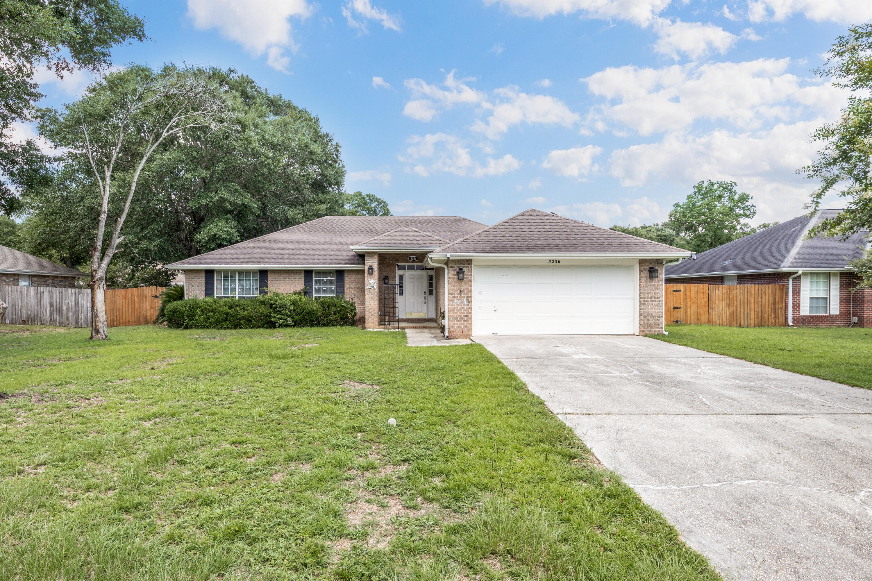 Welcome home to this 4-bedroom, 2-bathroom brick residence offering 1,783 square feet of comfortable living space in the Hawk's Nest community of Milton. Featuring a durable brick exterior and a roof replaced in 2018, this home combines lasting quality with thoughtful updates.

Step inside to discover a bright semi-open concept floorplan with a split-bedroom layout, creating the perfect balance of open entertaining space and private retreats. The spacious kitchen is designed for both everyday living and hosting guests, complete with stainless steel appliances, abundant cabinetry, and generous counter space to make meal preparation a breeze.

The primary suite offers a peaceful escape, while the additional bedrooms provide plenty of flexibility for family, guests, or a home office.

Out back, you'll love relaxing on the screened-in covered porch overlooking the fully privacy-fenced backyard. Need extra storage or workspace? The impressive 320-square-foot powered storage building is ideal for hobbies, a workshop, or storing lawn equipment and recreational gear.

Adding even more value, the home is equipped with solar panels, helping reduce monthly utility costs and providing long-term energy savings.

This move-in-ready home offers comfort, efficiency, and exceptional value. Schedule your private showing today!