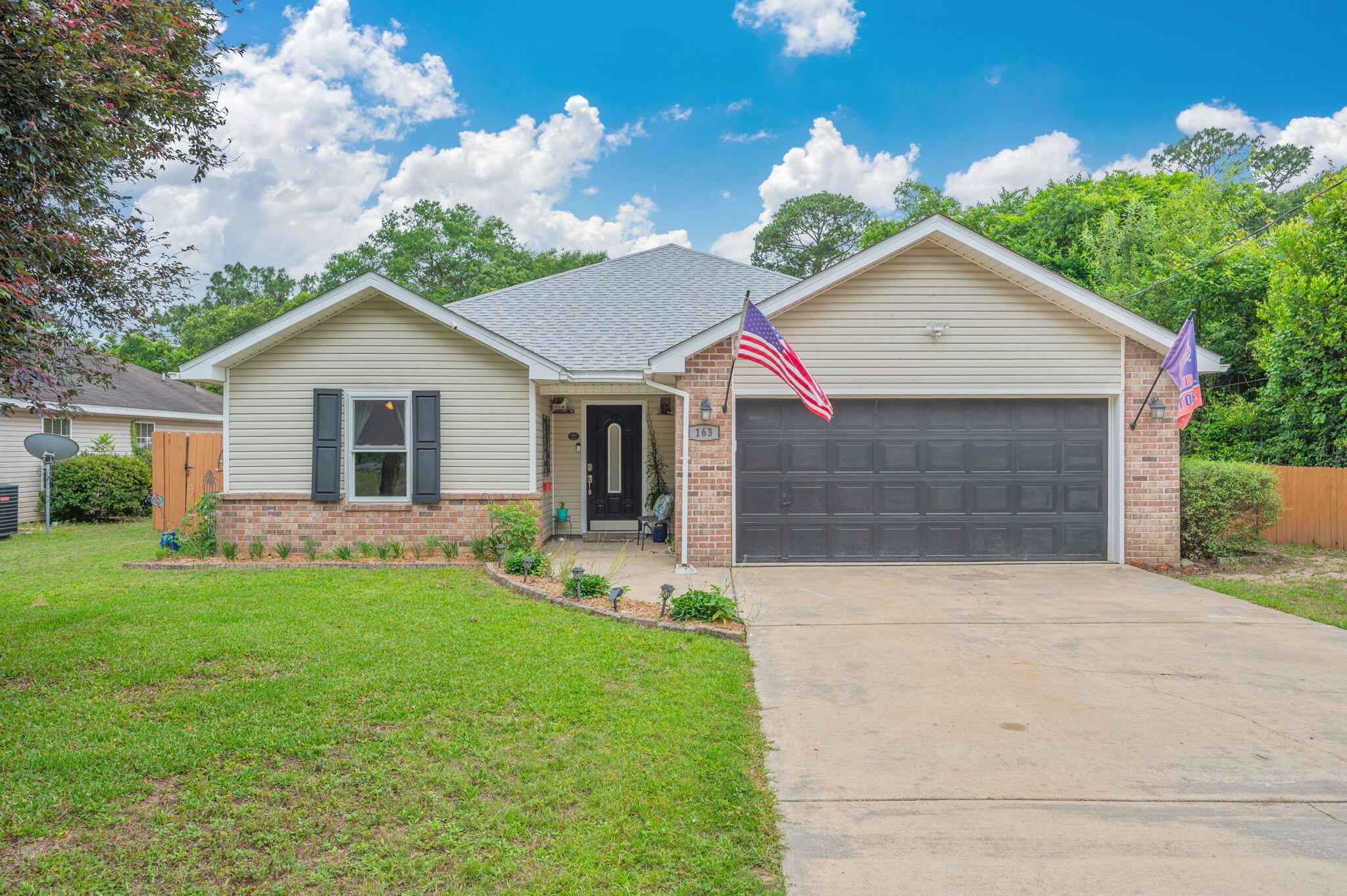 WELCOME HOME to 163 Jones Rd, beautifully maintained three bedroom, two bath home with vaulted ceilings, LVP flooring throughout, open floor plan and two car garage. The kitchen features a breakfast bar, lots of cabinets and counter space! 
Step outside to enjoy the large fenced backyard, perfect for gardening, gathering with friends or relaxing by the firepit! Low maintenance vinyl siding, with brick accents, gutters, large paver patio