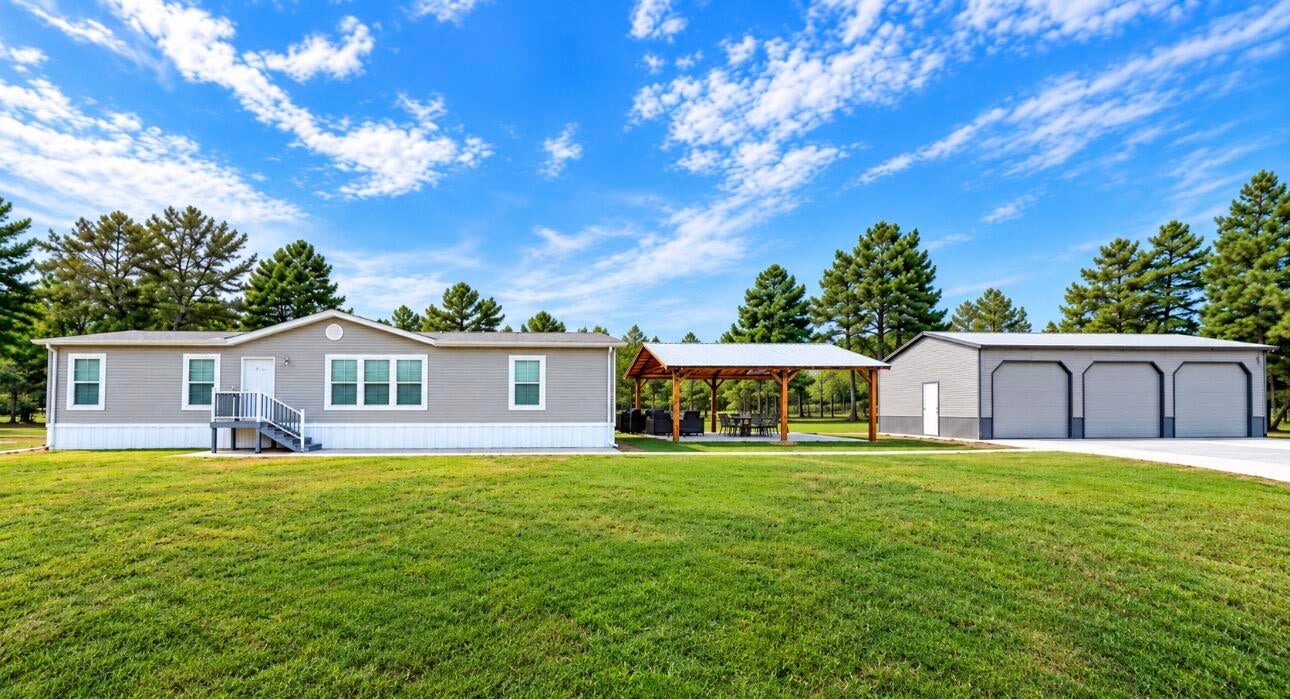 Stunning 3-bedroom, 2-bath manufactured home situated on 4 beautiful acres. The property is completely fenced and features a secure keyless-entry gate, providing privacy and convenience. A spacious 3-car garage with electricity offers plenty of room for vehicles, storage, hobbies, or workshop space. Enjoy the outdoors from the beautiful back deck, or gather with family and friends in the impressive pole barn/entertainment area.

The property offers plenty of space both inside and out and is ideal for those seeking privacy, storage, and room to entertain.