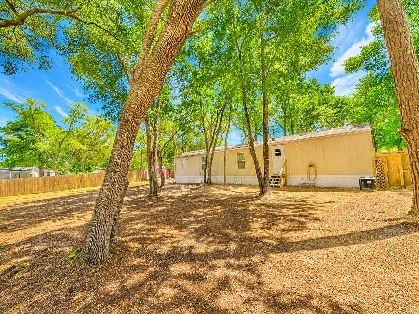 This charming, older 2-bedroom, 2-bath mobile home sits on a beautiful piece of property located in Southport. The home offers a cozy interior with a split floor plan, and outside you'll find a brand-new privacy fence with a double gate on each side and three versatile sheds, ideal for storage or projects. It's a quaint space ready for you to enjoy both inside and out! Great school zone, convenient to shopping, and less than 25 minutes to the beach.