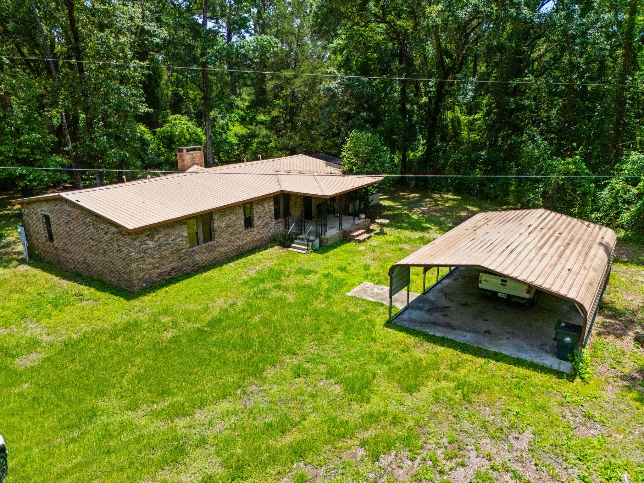 Riverfront property with just over 4 acres, no HOA, and plenty of room for boats, RVs, equipment, and outdoor recreation. Located near the Choctawhatchee River Bridge and public boat ramps, this property offers the space and flexibility that's becoming increasingly difficult to find.

This 3-bedroom, 2-bath brick home offers 2,278 square feet with a spacious floor plan, updated kitchen, large living area with fireplace, and an enclosed sunroom overlooking the property. The kitchen features custom cabinetry, stainless steel appliances, a gas range, and center island. The primary suite includes a walk-in closet and updated bath with double vanities.

Outside, you'll find multiple outbuildings, workshop space, storage buildings, oversized covered parking for boats and RVs, and plenty of room for hobbies, projects, and recreational equipment. A private well, septic system, natural gas, metal roof, and abundant parking add to the property's appeal.

An additional parcel (36-1N-17-04040-00B-0050) containing approximately 0.247 acres is included in the sale, bringing the total acreage to approximately 4.07 acres. Whether you're looking for a full-time residence, weekend retreat, or a property with room to spread out and enjoy the outdoors, this unique property offers endless possibilities.