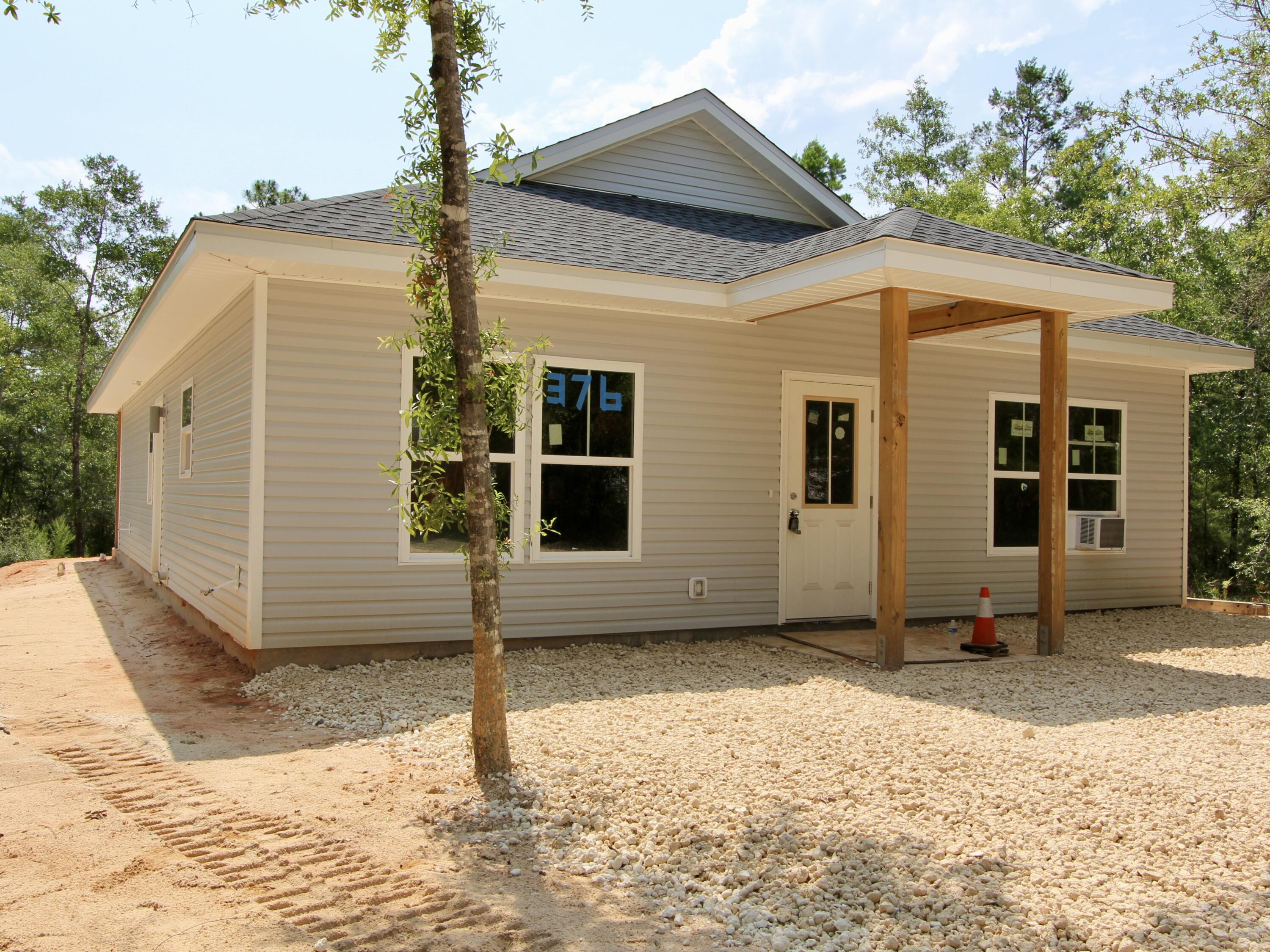 Experience the perfect blend of peaceful country living and everyday convenience in this brand-new 3-bedroom, 2-bath home on W. Michelangelo Road in DeFuniak Springs, Florida. Situated on a spacious, private homesite, this property offers plenty of room to add a pool, create your dream outdoor entertaining space, or simply enjoy the privacy and tranquility of your backyard.

Inside, you'll find a thoughtfully designed open floor plan featuring beautiful luxury vinyl plank flooring throughout the main living areas and elegant quartz countertops that add a modern touch to the kitchen and bathrooms. The bright, open layout is perfect for both everyday living and entertaining.

Located just minutes from shopping, dining, schools, and downtown DeFuniak Springs, you'll enjoy the best of both worlds--quiet country surroundings with town conveniences nearby. Plus, you're only about 30 minutes from the sugar-white beaches and emerald waters of Florida's Gulf Coast.

Enjoy peace of mind with a full builder's warranty and the freedom of no HOA fees or restrictions. Whether you're looking for your first home, a retirement retreat, or an investment, this new construction home offers quality, comfort, and an unbeatable location.