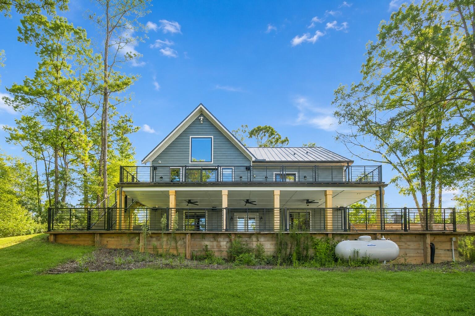 Welcome to this beautifully crafted lakefront retreat tucked away in the peaceful Blue Cypress community. Built in 2024 and never lived in, this home offers approximately 2,509 square feet of comfortable living space surrounded by the natural beauty of Northwest Florida.
Designed with a warm, modern cabin feel, the home features raised ceilings, a fireplace, spacious kitchen, office, generous bedrooms and beautiful lake views. Step outside and enjoy the covered patio, open deck, balcony and your own dock overlooking the quiet water.
Offered **fully furnished**, this is an opportunity to simply arrive, unpack and start enjoying the property. Whether you're searching for a full-time residence, weekend getaway or private family retreat, 172 Blue Pond Circle offers a rare combination of newer construction, waterfront living and peaceful country surroundings. Tucked away from the crowds, yet still within easy driving distance of Crestview and DeFuniak Springs, this is the kind of property that feels like an escape every time you come home.